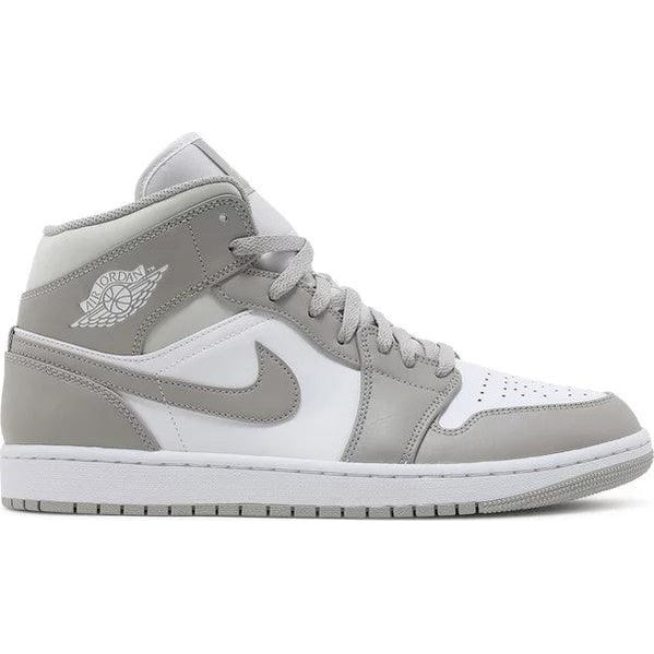 Grey and white mid-top sneaker with Nike swoosh and perforated toe, side view
