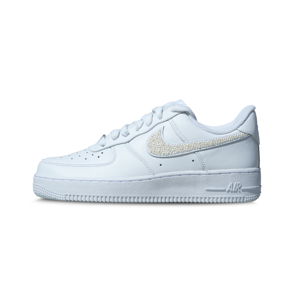 White designer sneaker with crystal embellished swoosh, classic low-top streetwear style