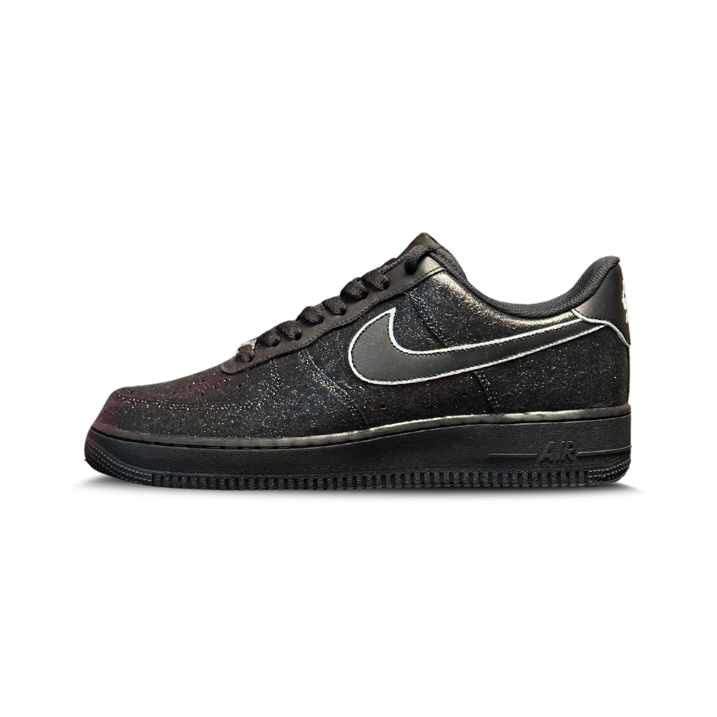 Black Nike Air Force 1 low-top sneaker with silver swoosh and glitter detailing on white background