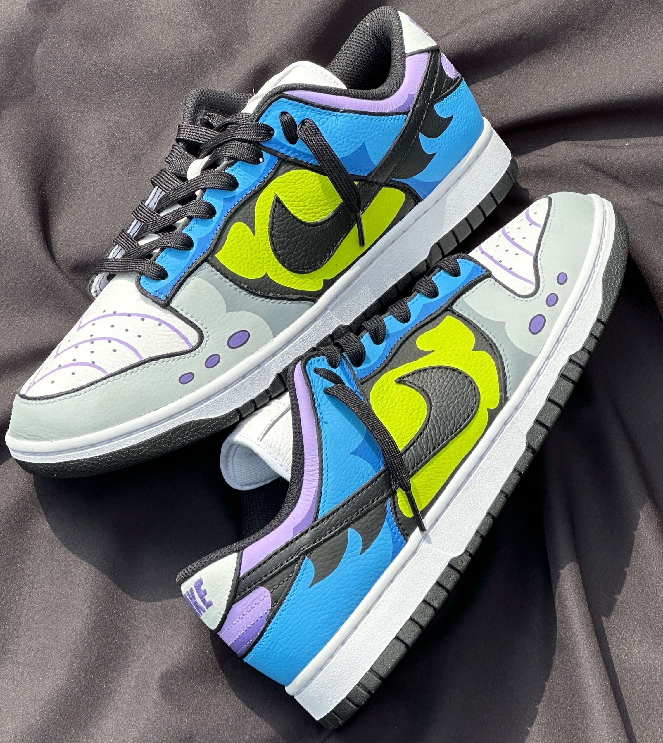 Colorful streetwear sneakers with bold graphic patterns, black swoosh, and vibrant accents