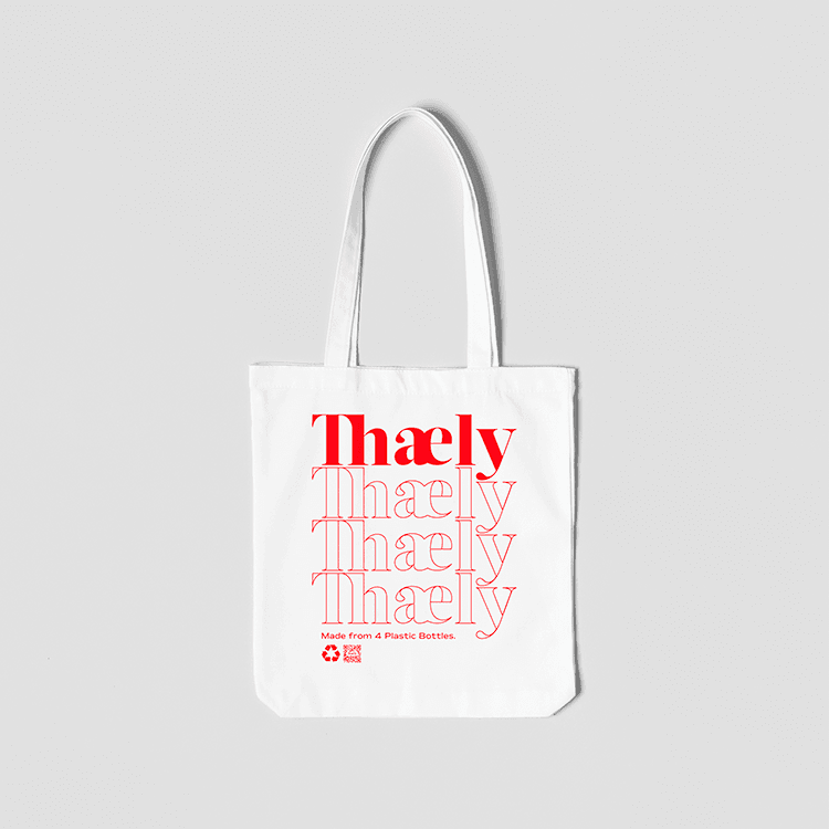 White eco-friendly tote bag with red text 'Thaely', made from recycled plastic bottles