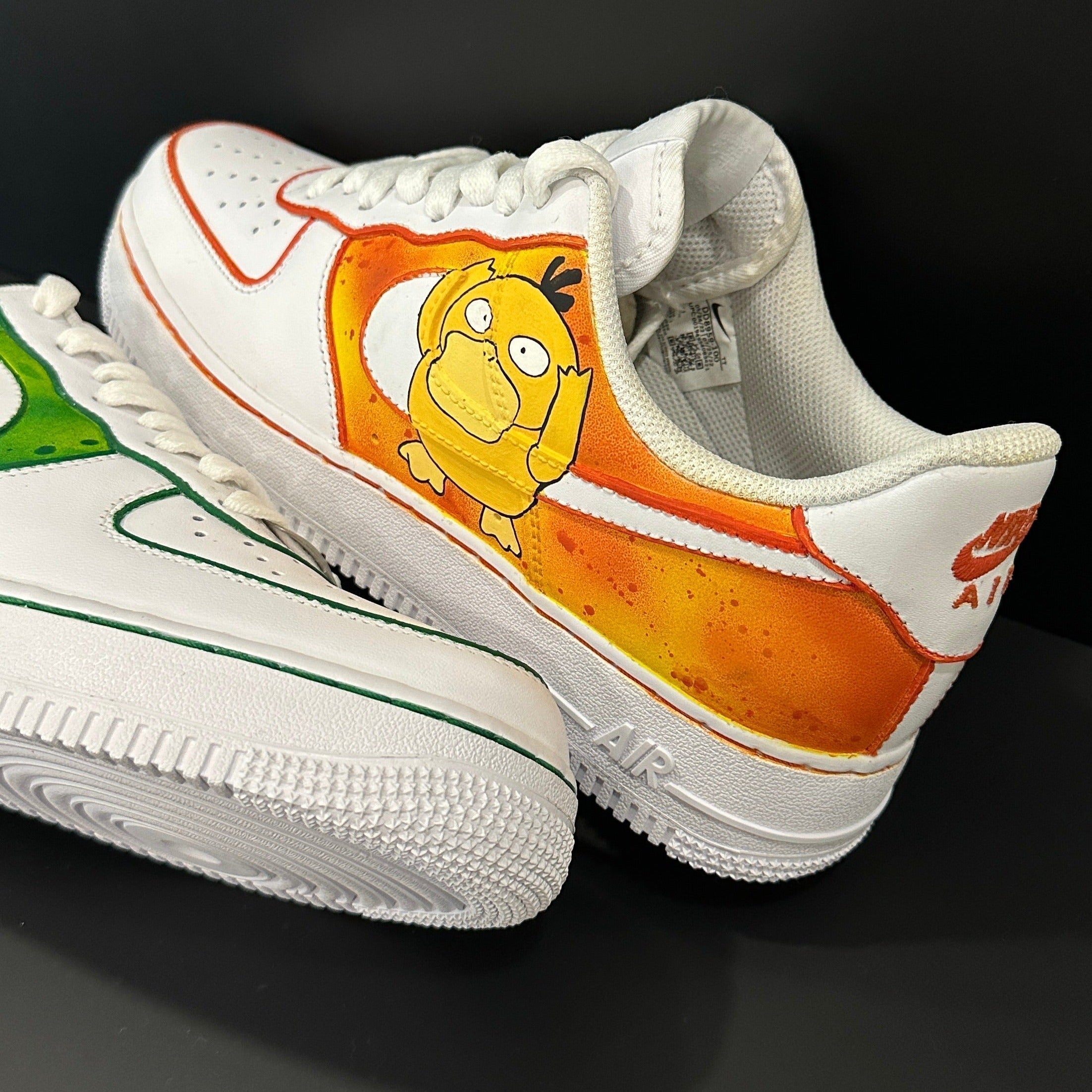 Custom Nike Air Force 1 sneakers with Psyduck cartoon and orange accent on white leather