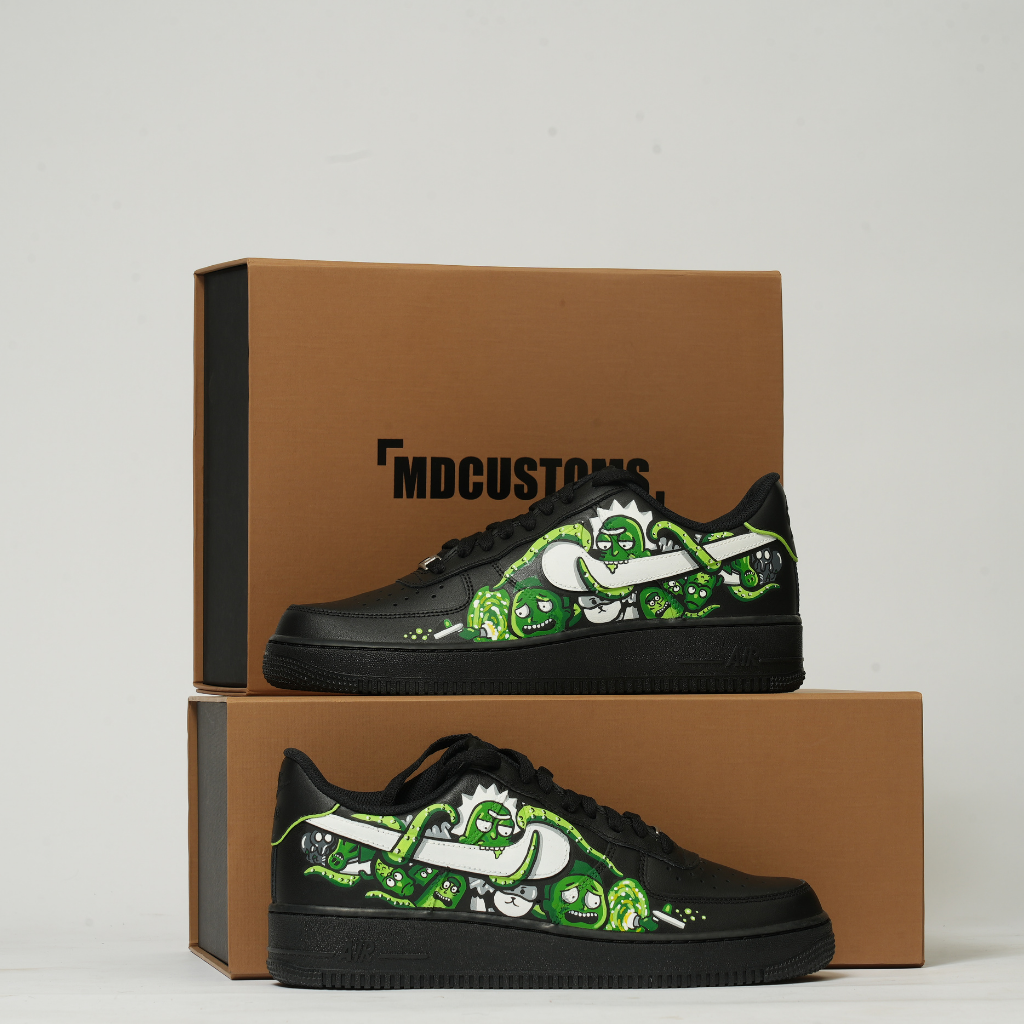 Black custom streetwear sneakers with bold green cartoon graphics, displayed on brown shoe boxes