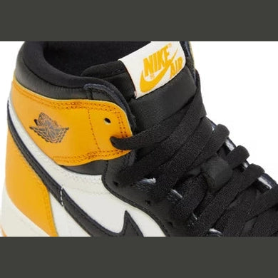 Yellow, black, and white Nike Air Jordan high-top sneaker with visible logo details