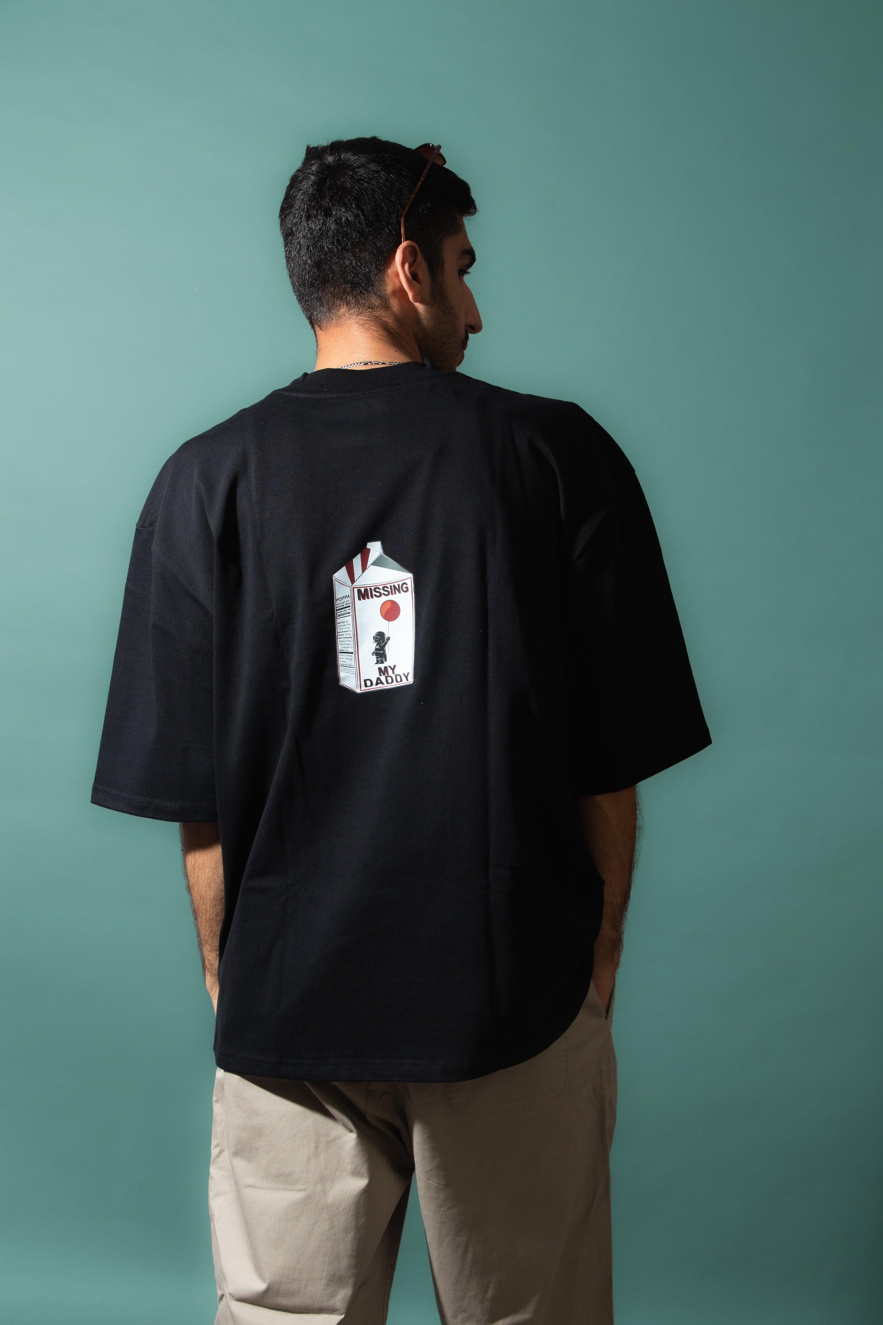 Man wearing black streetwear t-shirt with 'Missing My Daddy' milk carton graphic on back