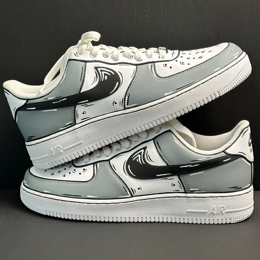 Custom cartoon-style grey and white low-top sneakers with bold black accents on a black background
