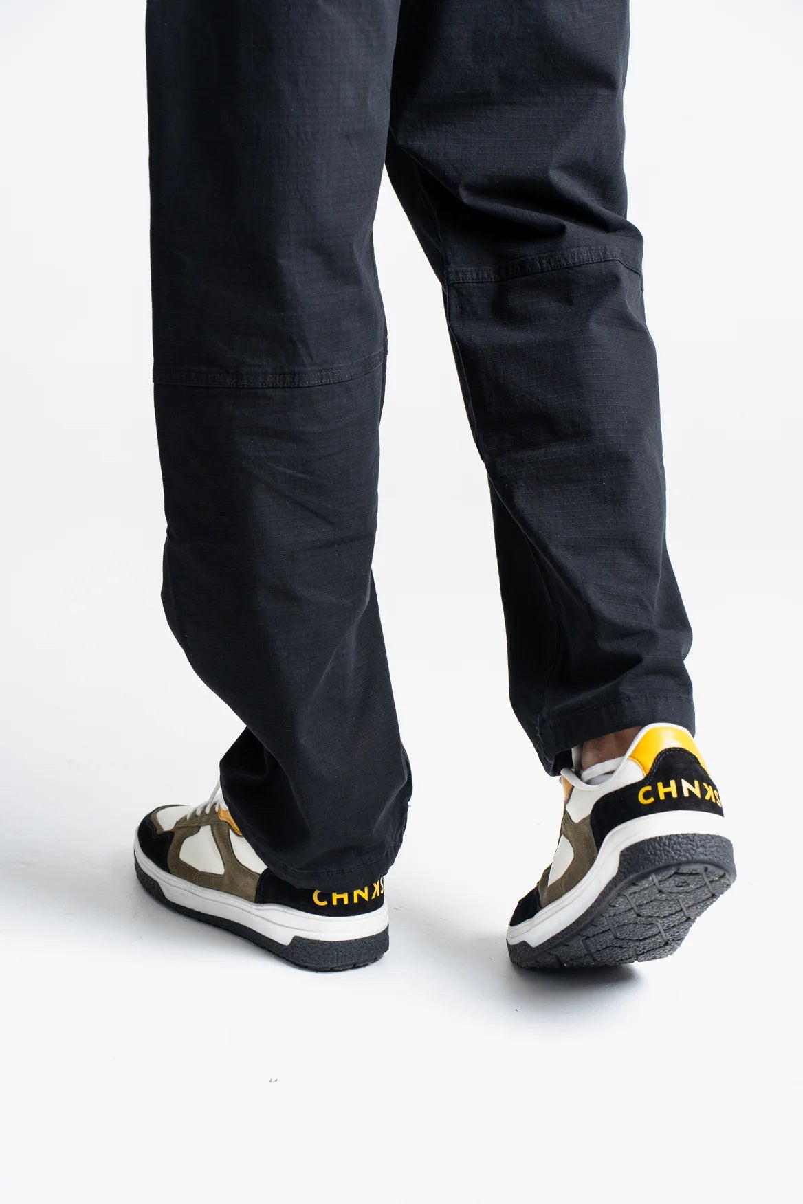 Taxi CHNKS sneakers on leg – men’s yellow and green sneakers for casual and streetwear fashion