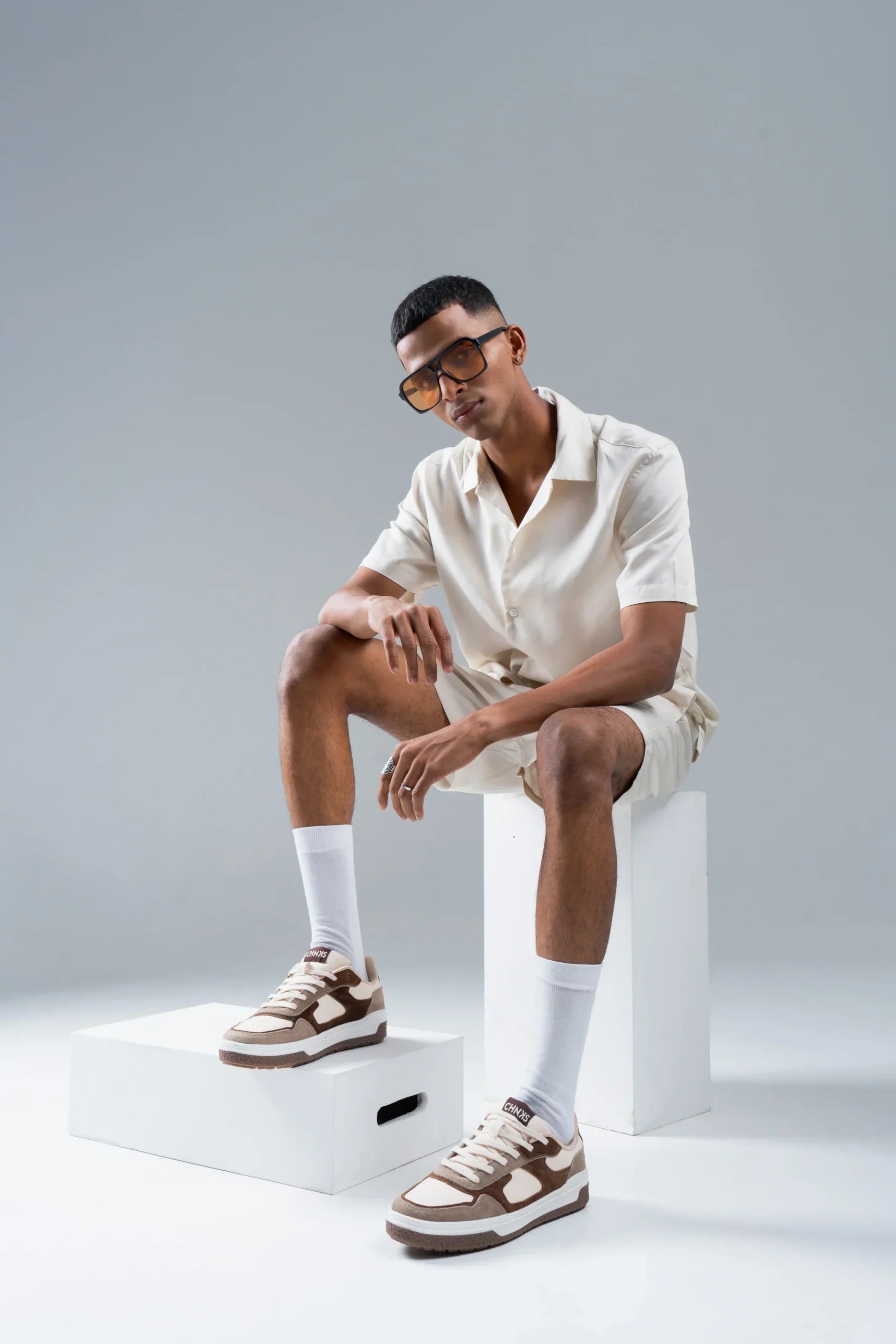 Man wearing Affogato CHNKS brown sneakers with off-white shirt and shorts – minimalist men’s streetwear