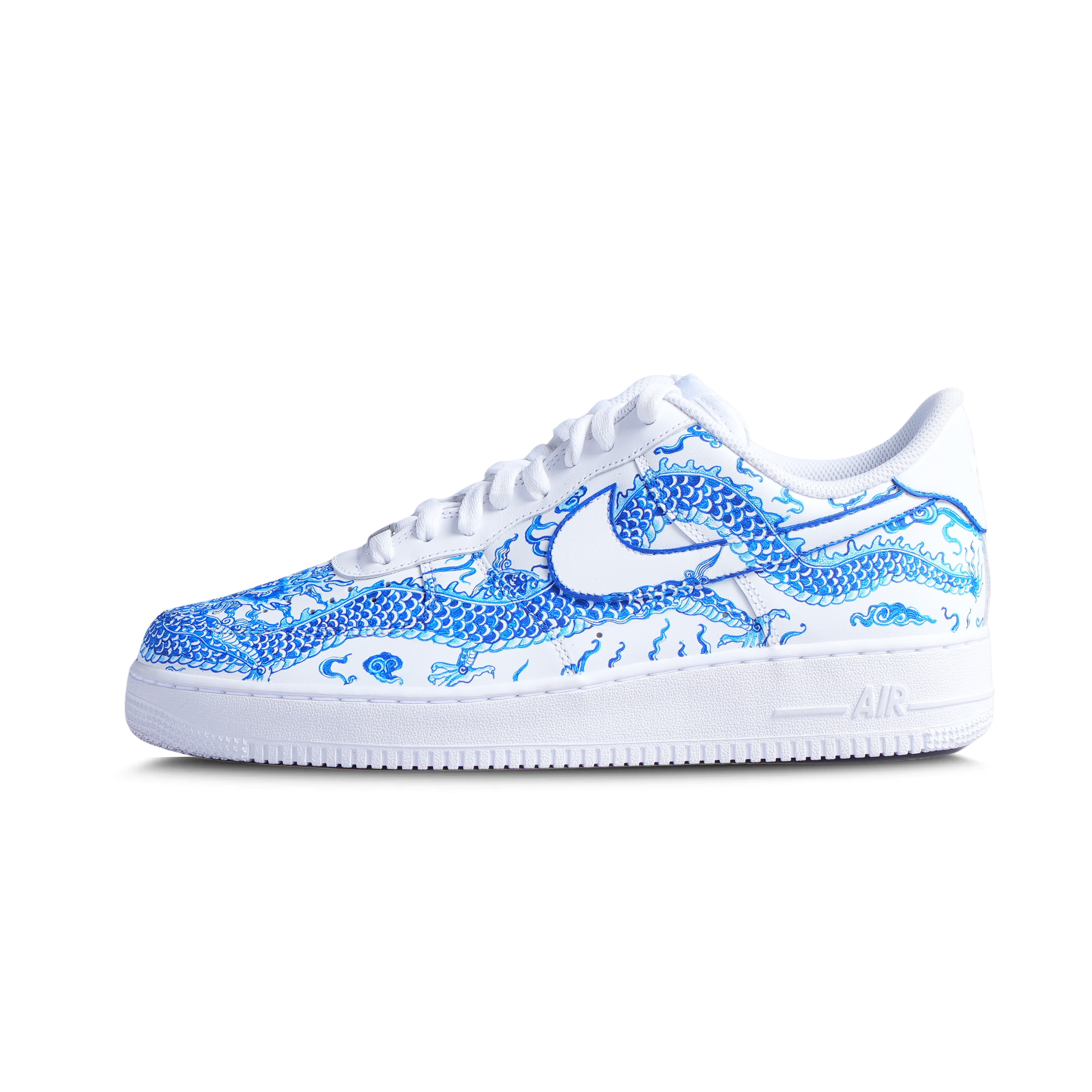 White sneaker with blue dragon graphic, streetwear-inspired, side profile on white background