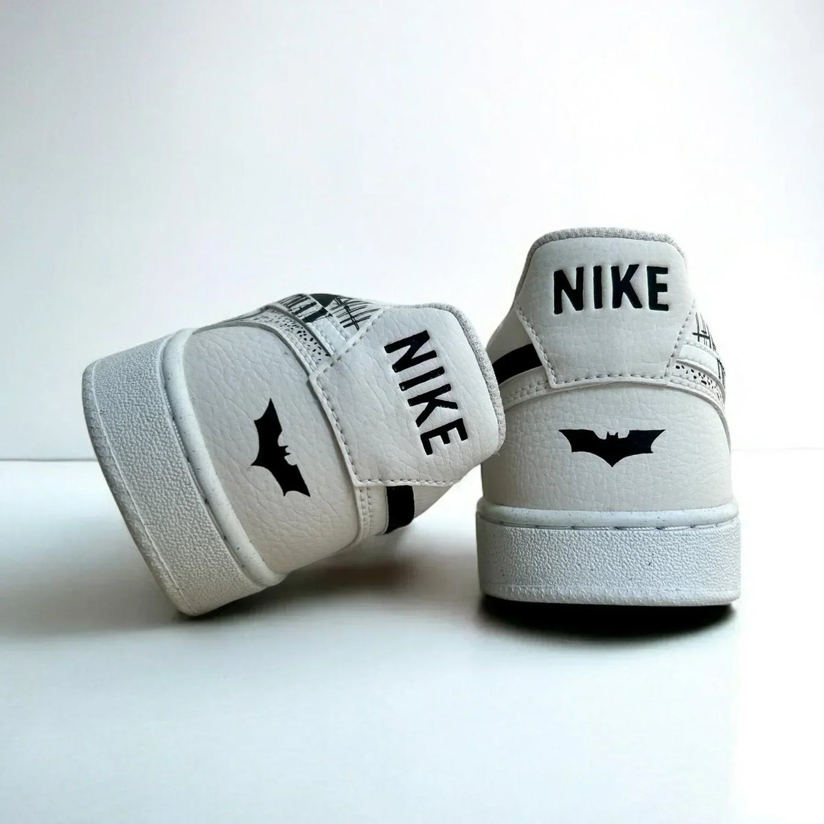 White Nike Court Vision custom sneakers with black bat graphic on heel, streetwear style
