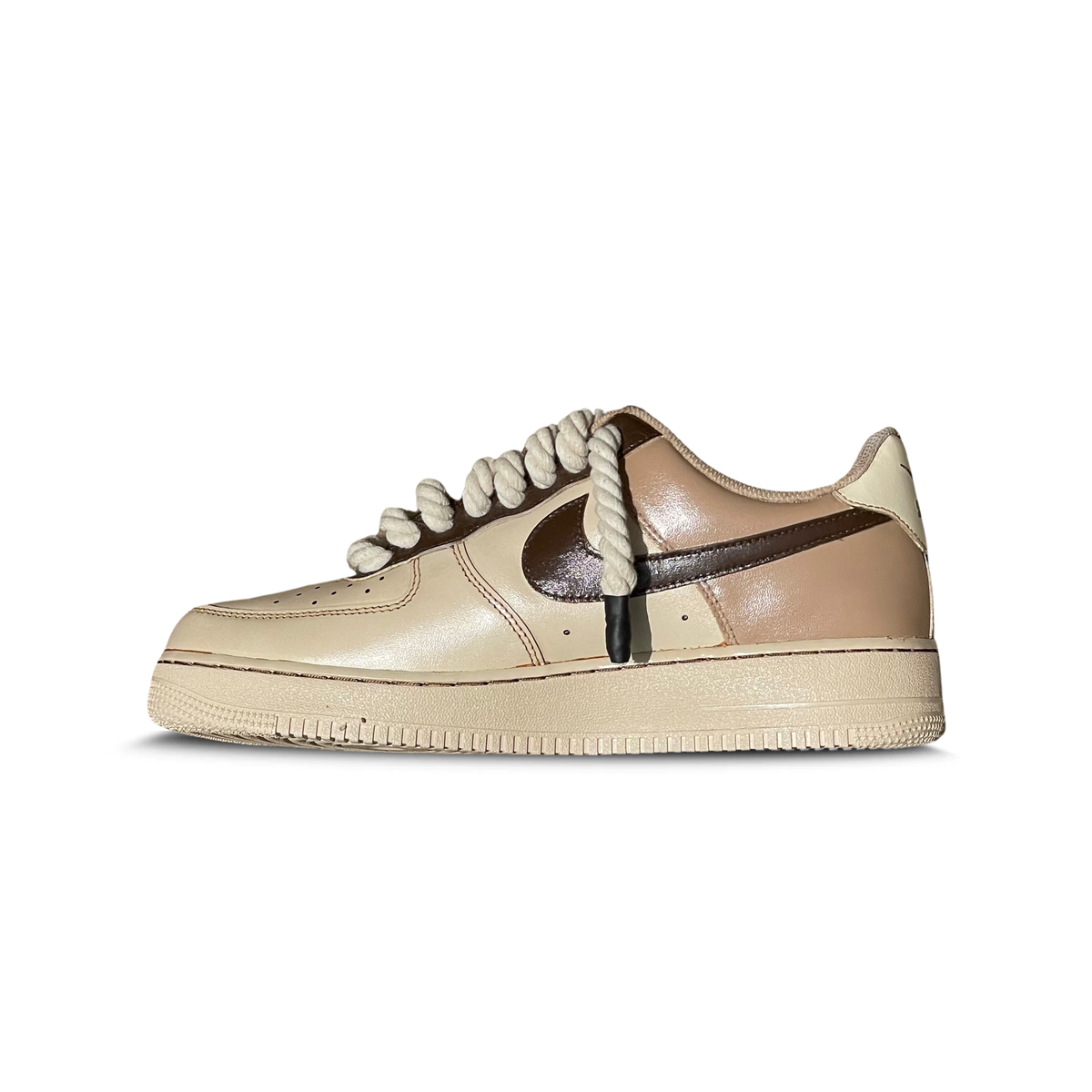 Beige and brown low-top sneaker with chunky laces and glossy leather finish, side view