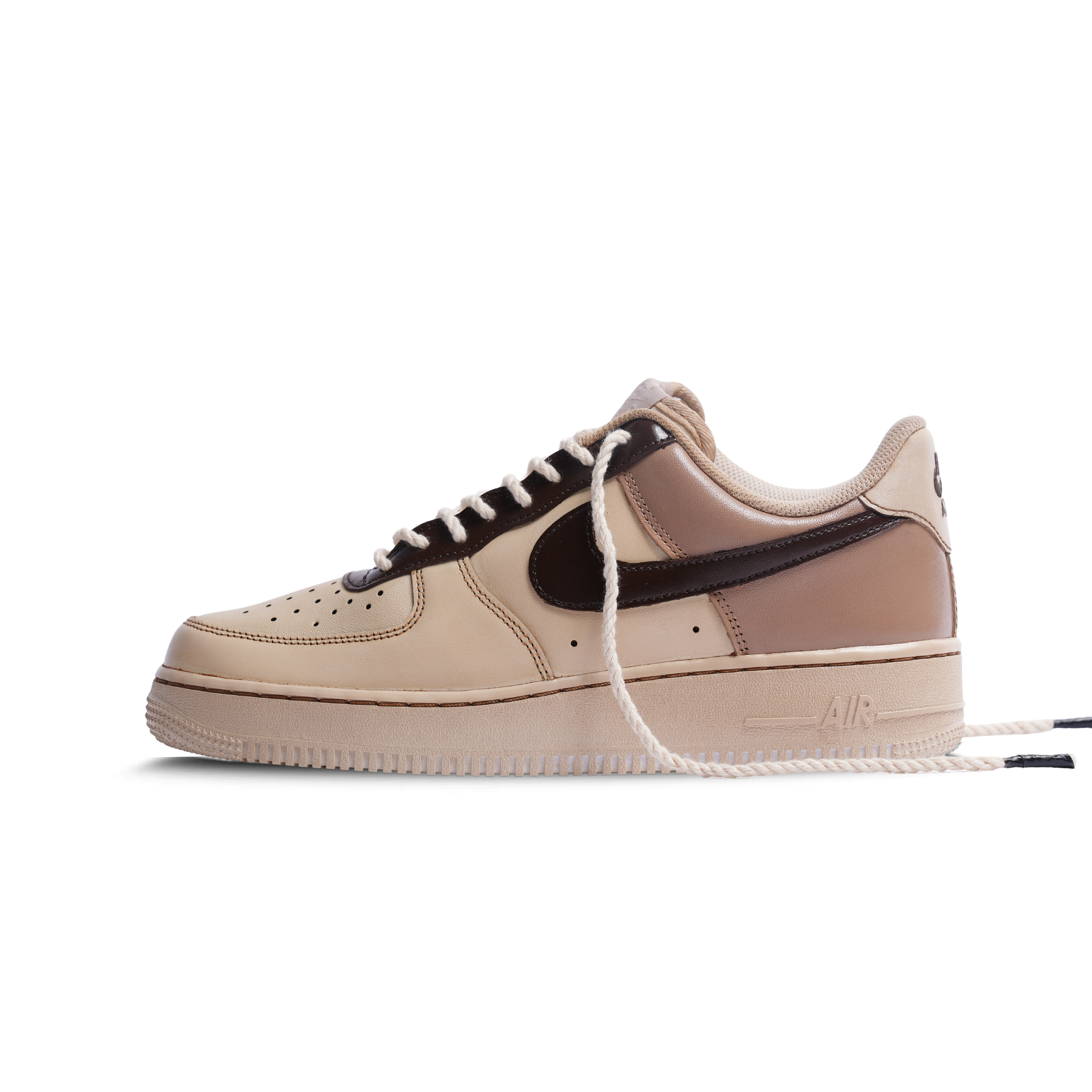 Beige and brown low-top sneaker with dark swoosh, rope lace, and streetwear style.