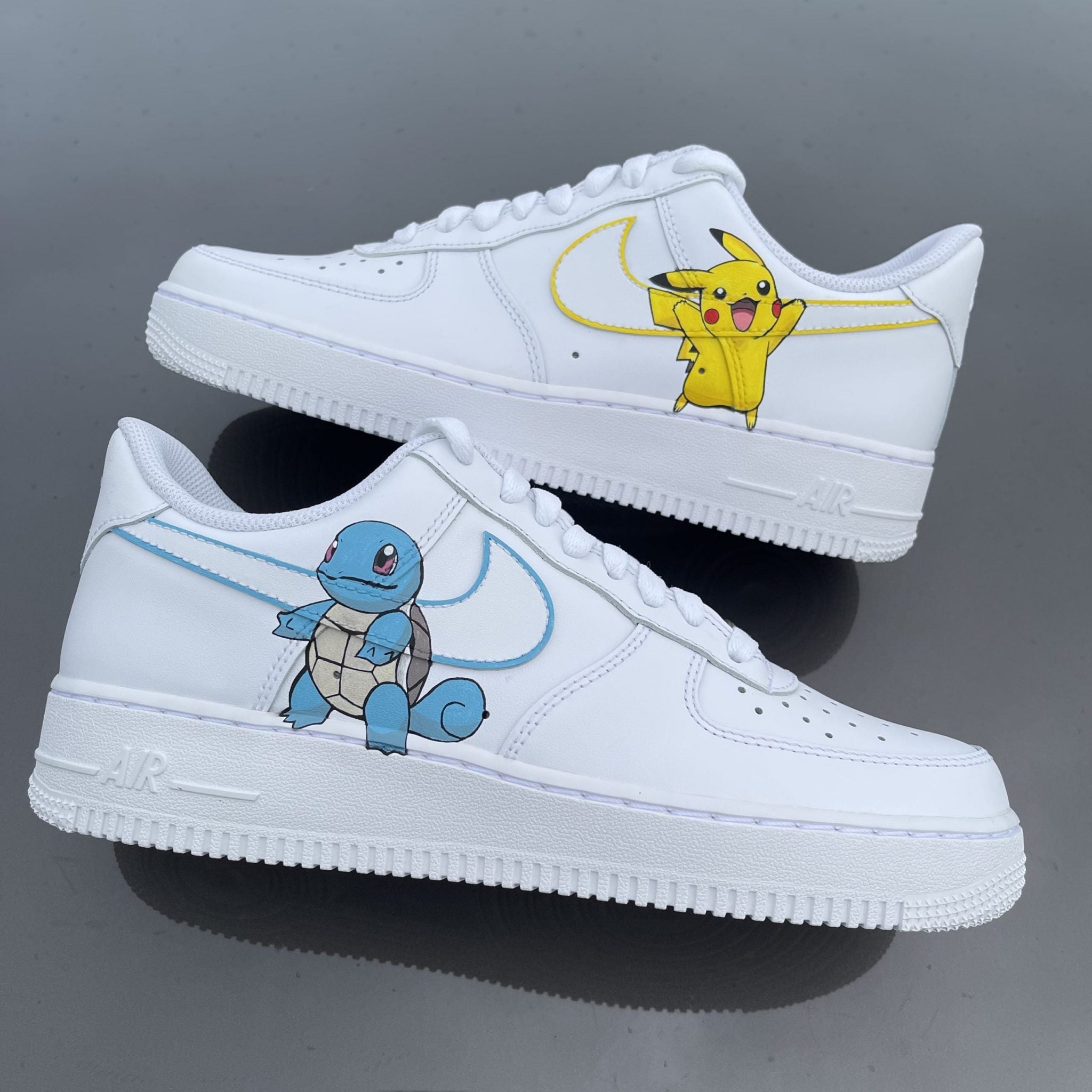White custom Air Force 1 sneakers featuring Pikachu and Squirtle artwork on the sides.