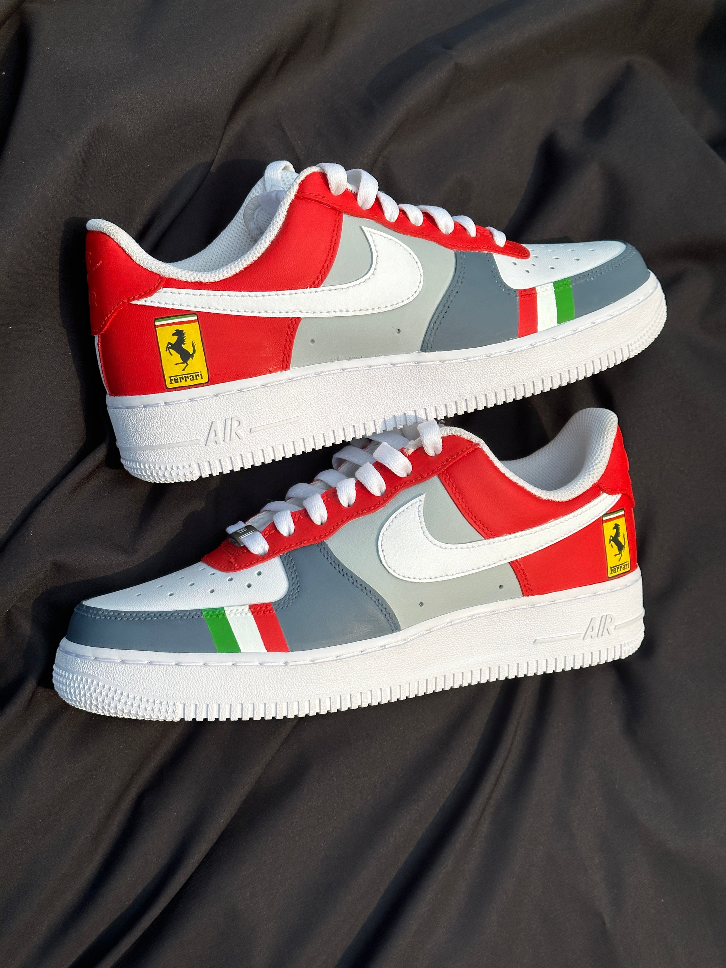 Red, white, and grey streetwear sneakers with Ferrari logo and green and red accents on side.