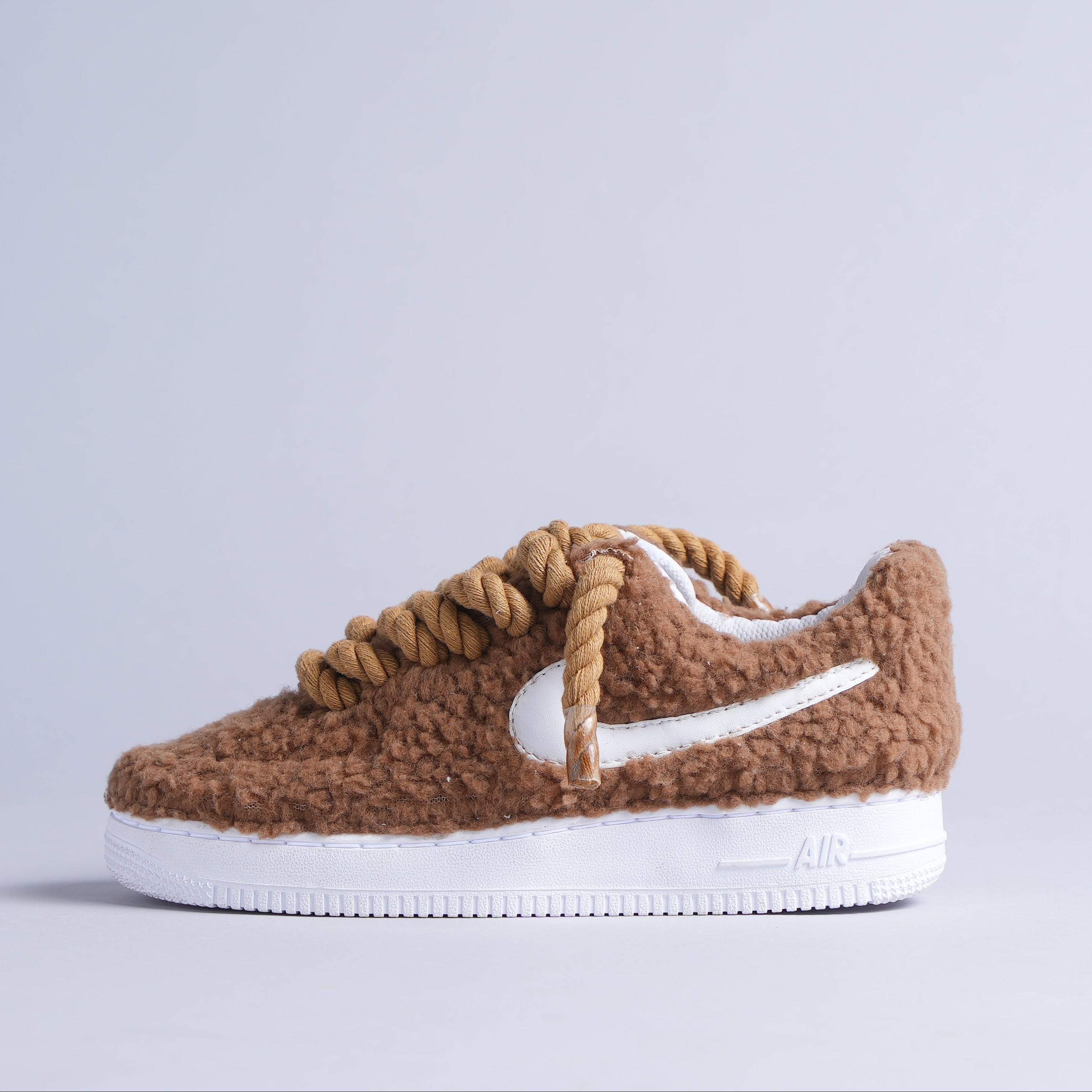 Brown sherpa-textured sneaker with chunky laces and white sole, streetwear shoe