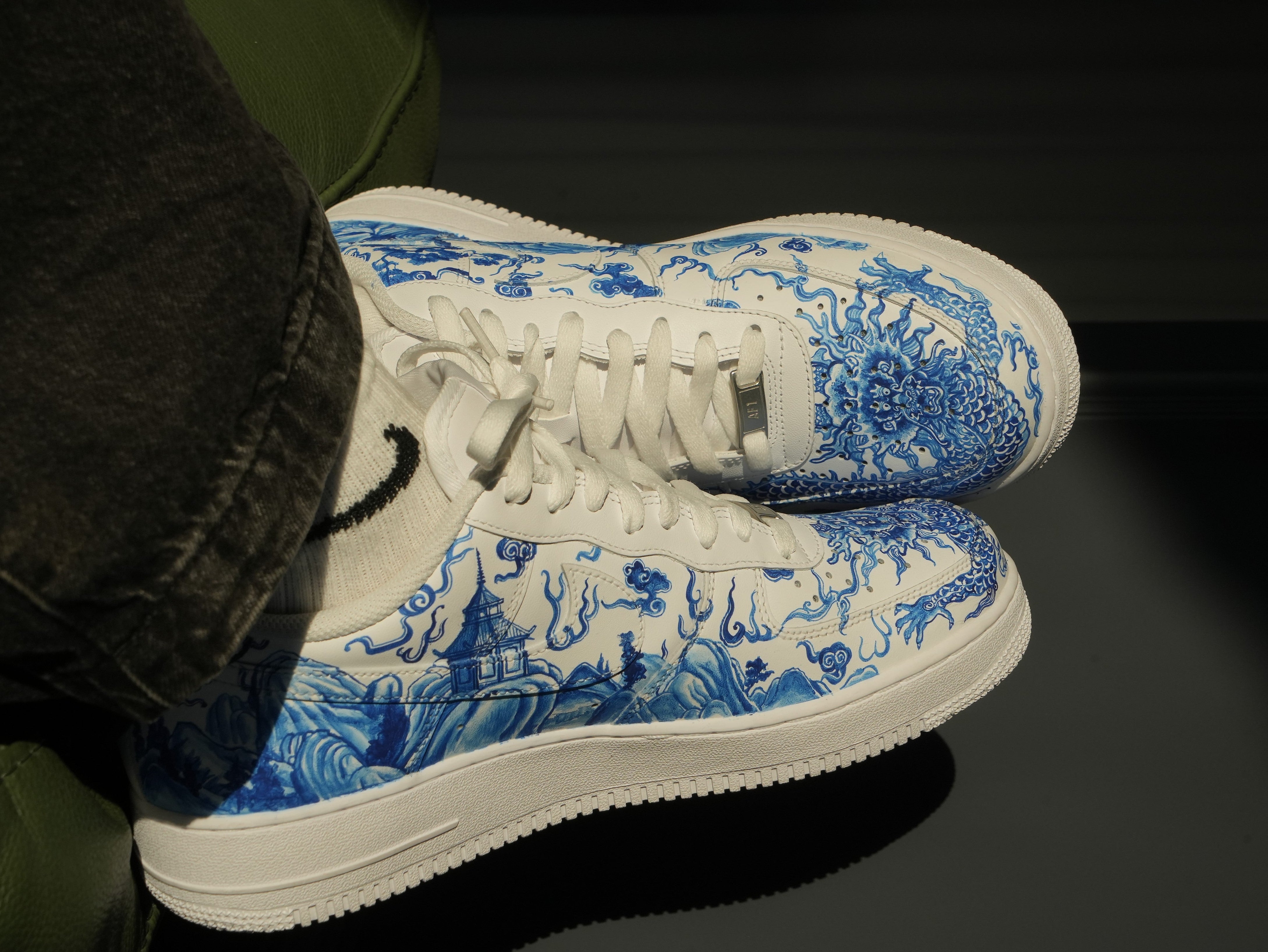 White sneakers with blue dragon and landscape design, streetwear footwear style