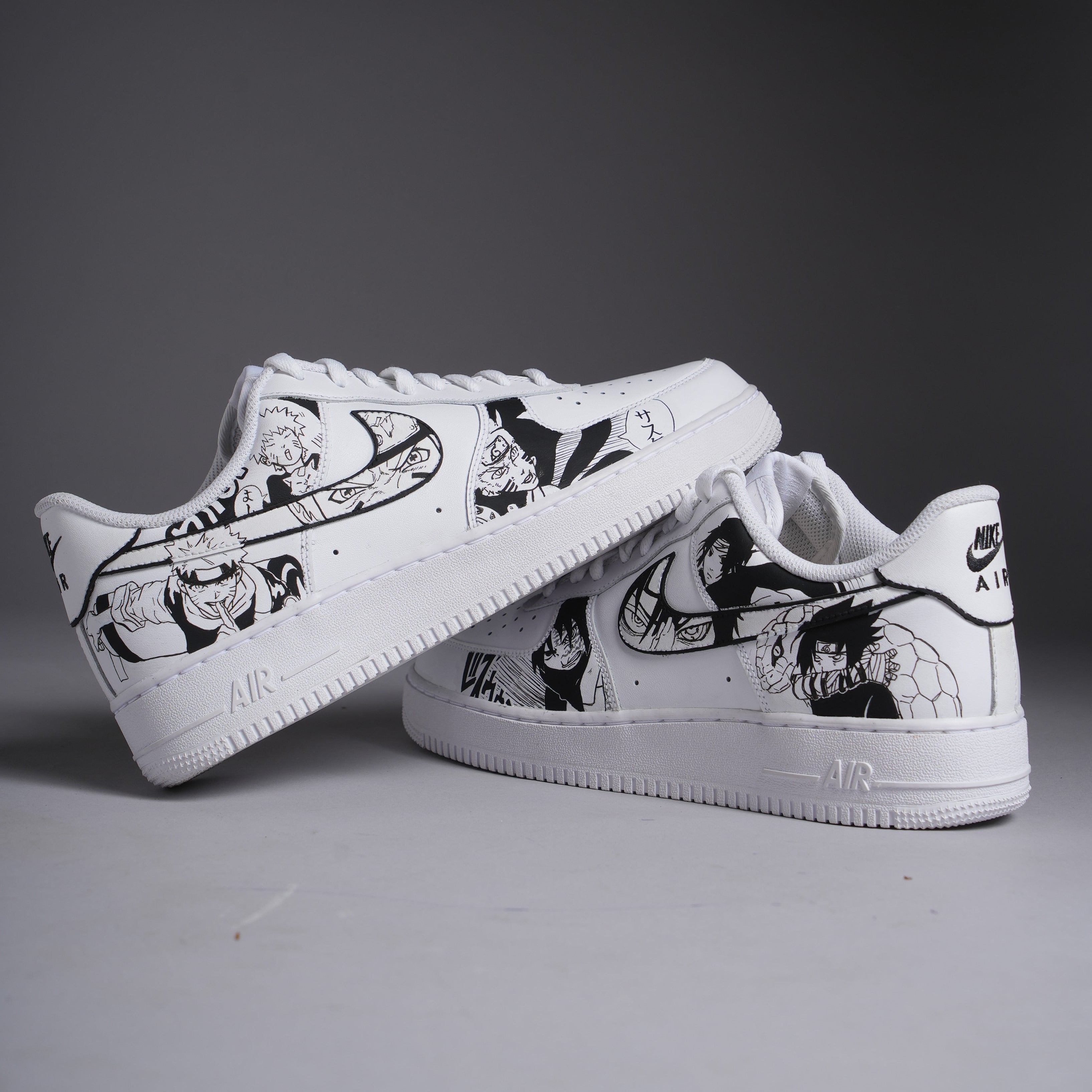White Nike Air Force 1 sneakers with black anime character graphics, streetwear style