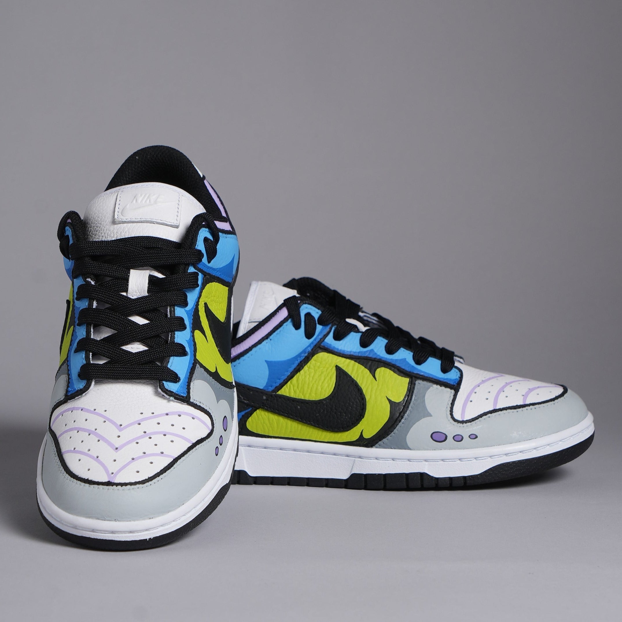 Colorful Nike Dunk sneakers with blue, yellow, and black accents on a grey background