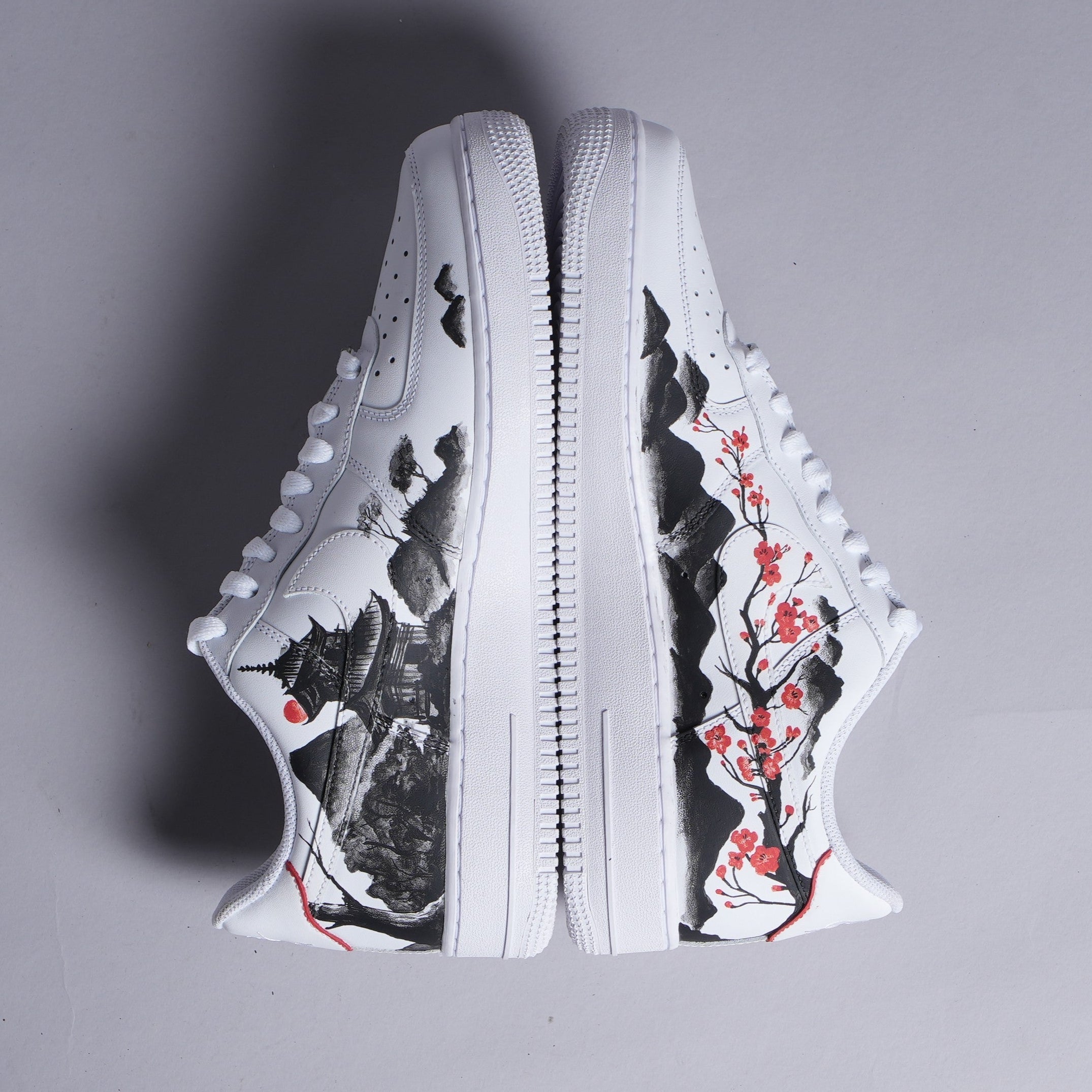 White streetwear sneakers with Japanese-style temple, mountain, and cherry blossom artwork