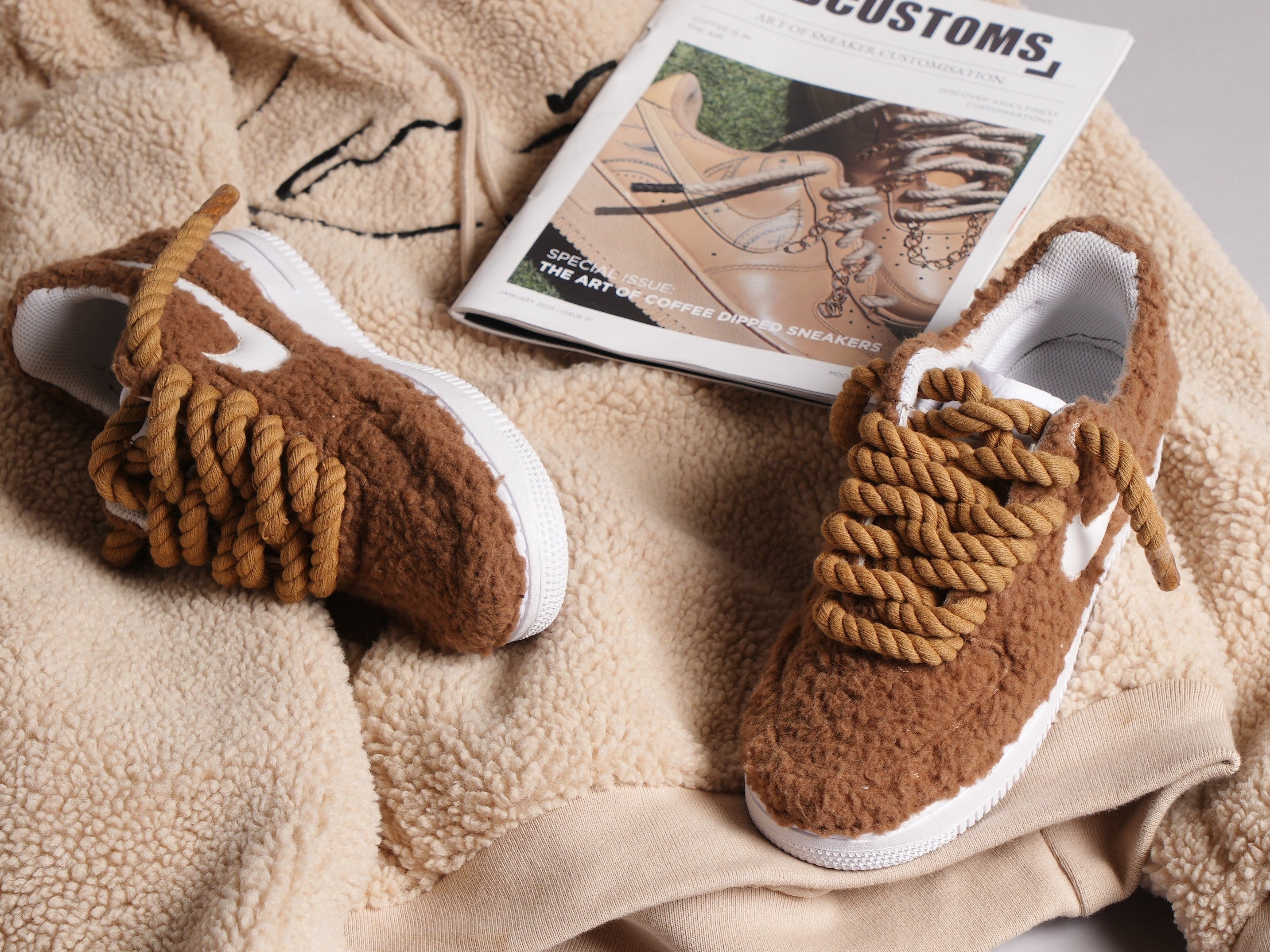 Brown sherpa sneakers with thick rope laces on beige fleece with sneaker magazine