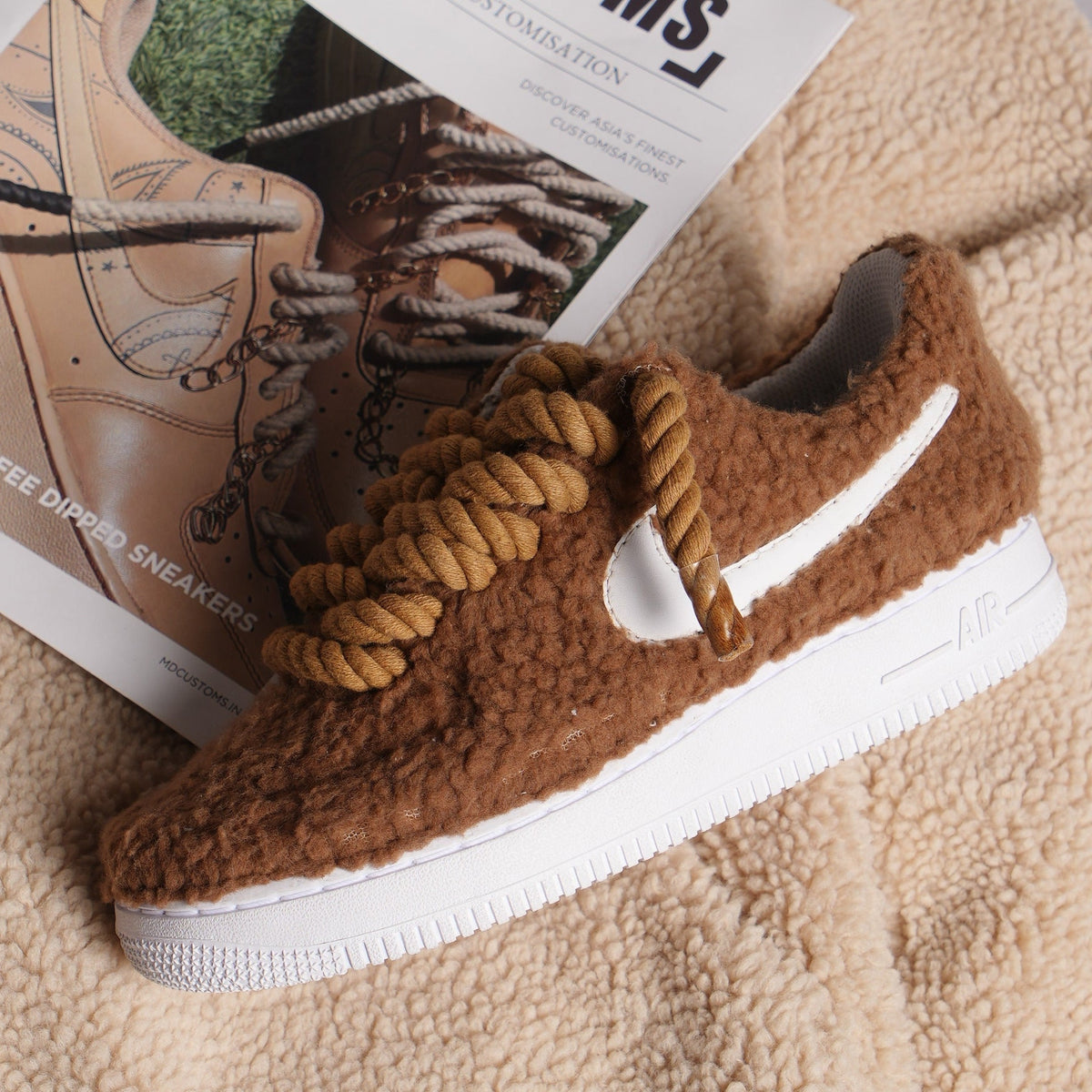 Brown sherpa fleece sneaker with chunky rope laces and white sole on textured fabric