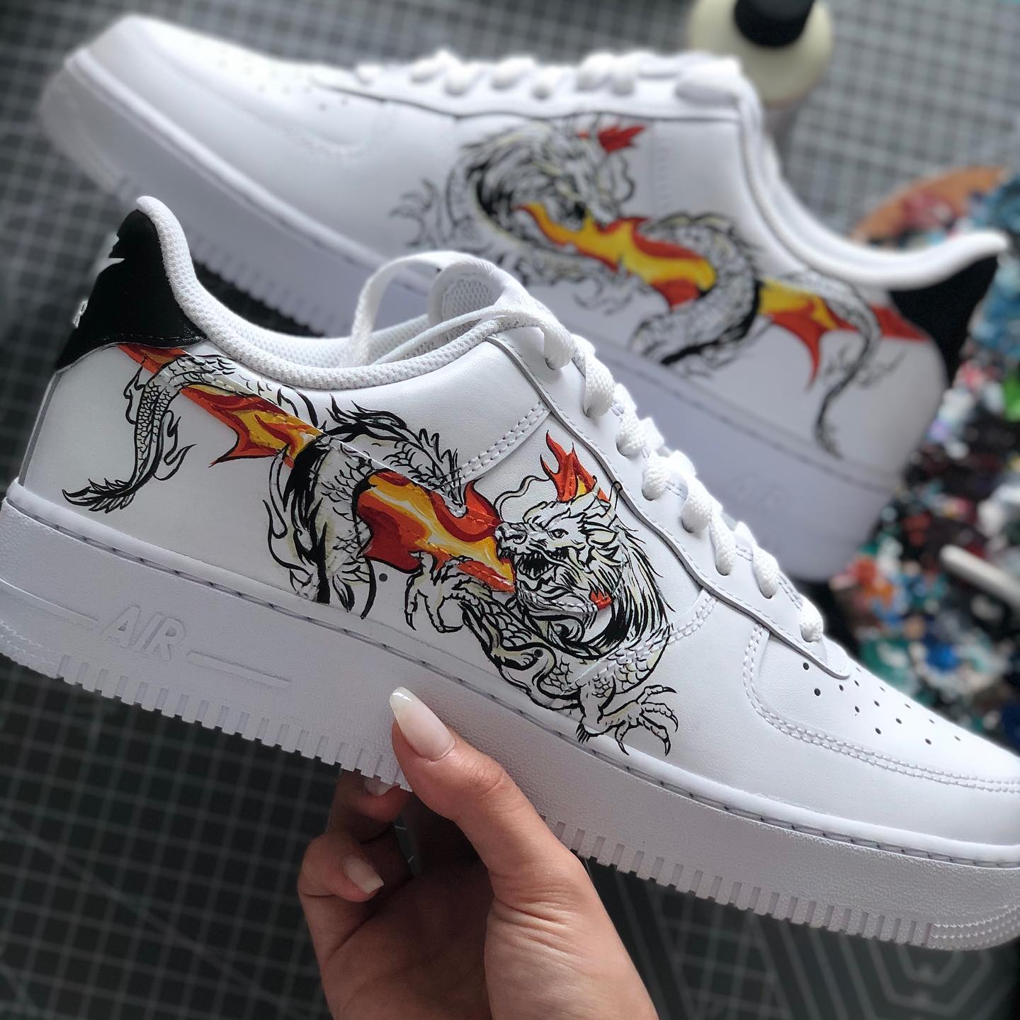 White Air Force 1 sneaker with custom hand-painted dragon and flame design, streetwear style