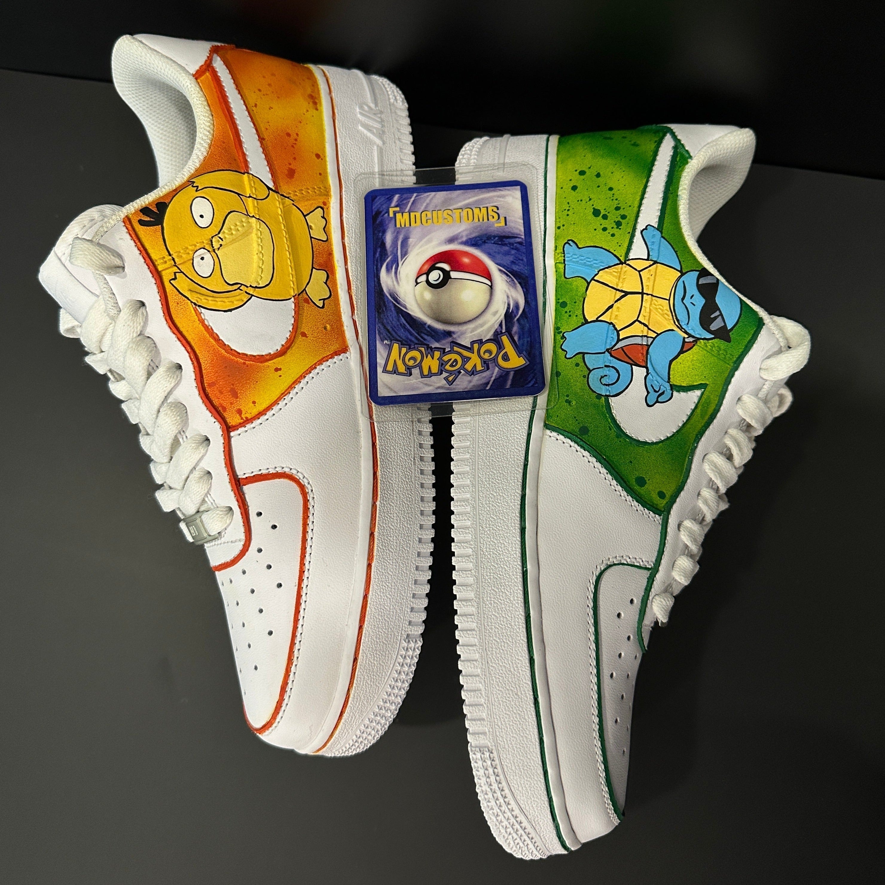 Custom white sneakers with Psyduck and Squirtle artwork, Pokémon card on top, on black background