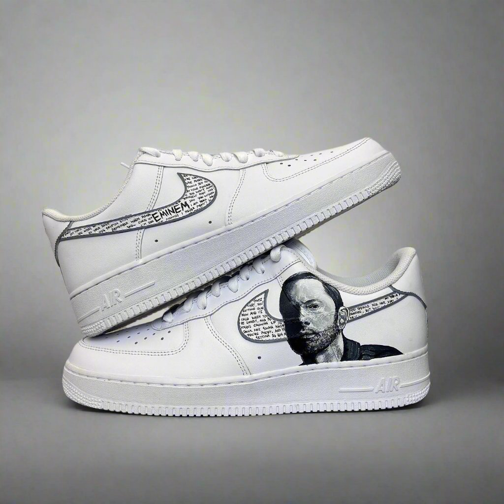 Custom white Nike Air Force 1 sneakers with hand-drawn Eminem portrait and lyric details.