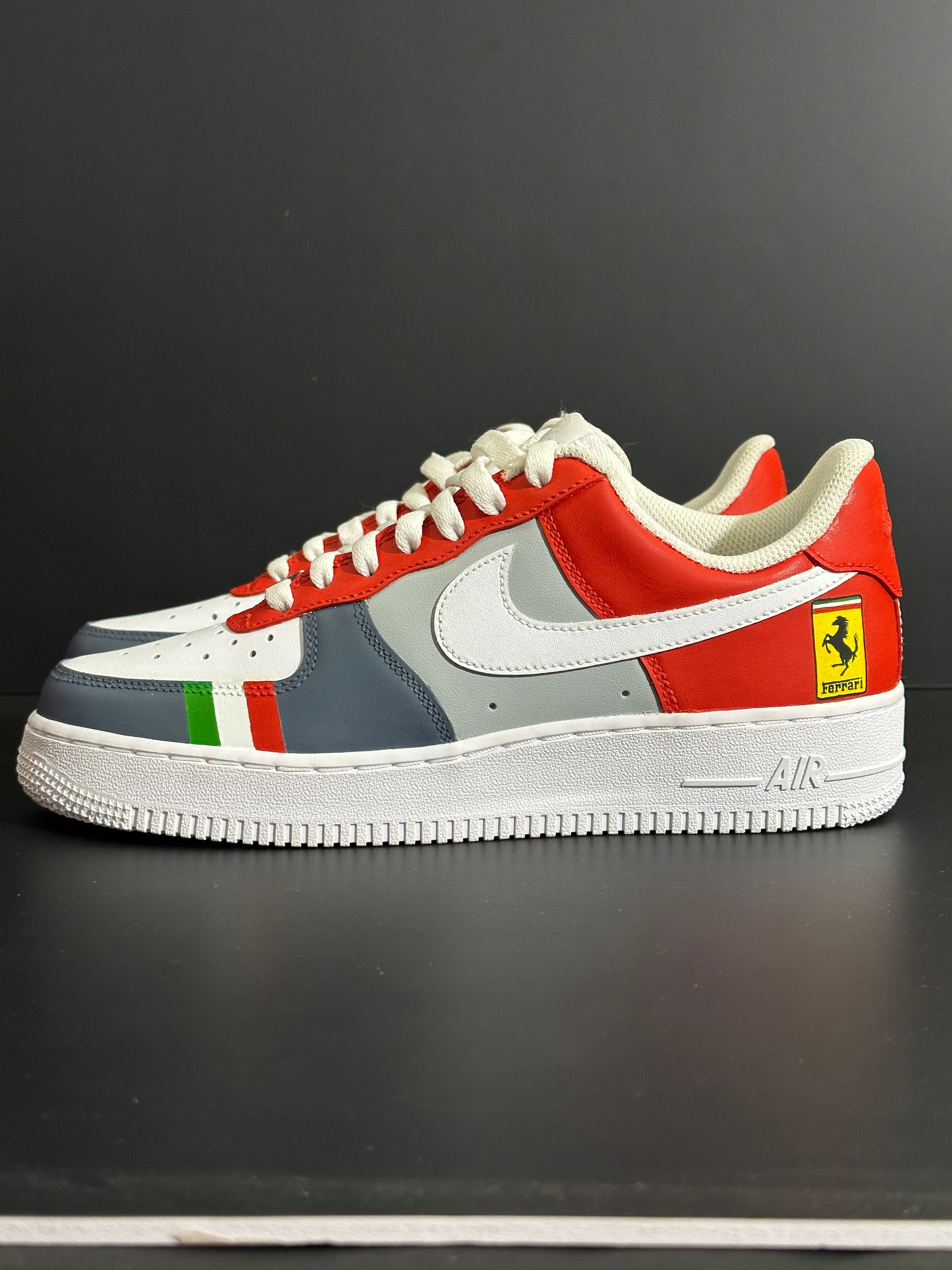 Red, white, and gray streetwear sneaker with Italian flag stripes and Ferrari logo on heel