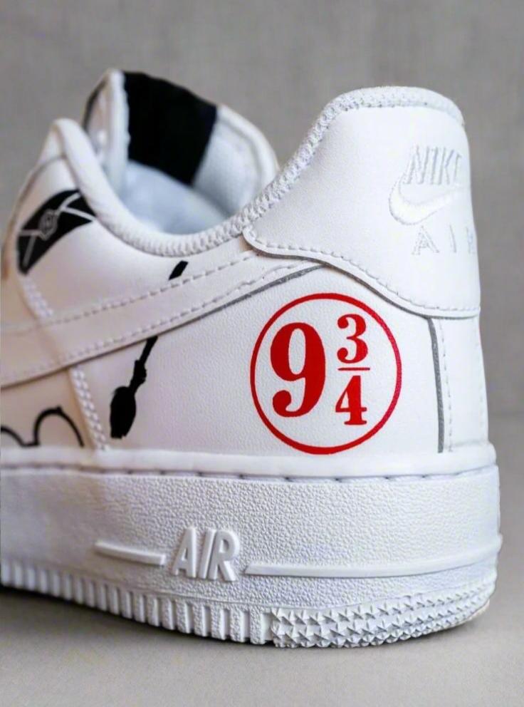 Custom white Nike Air Force 1 sneaker with red 9 3/4 detail and broomstick graphic