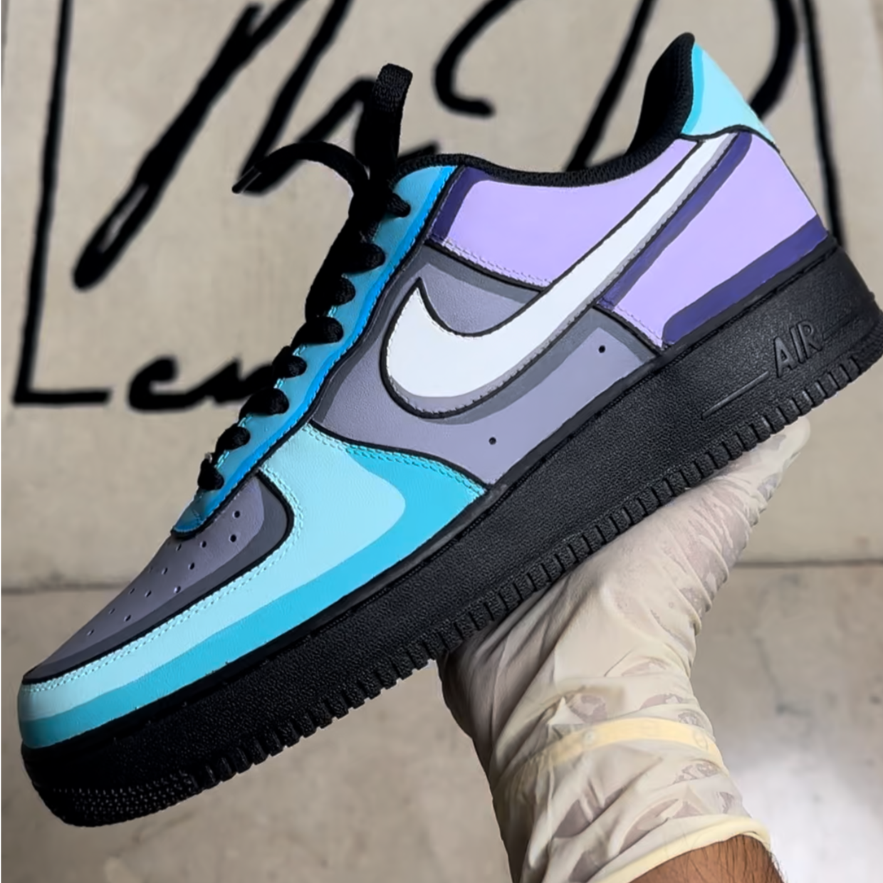 Custom streetwear sneaker with blue, purple, and gray color blocking, black sole, and white swoosh.