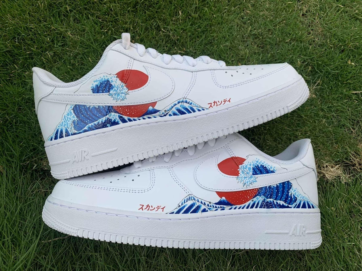 White streetwear sneakers with Japanese wave and red sun design on grass