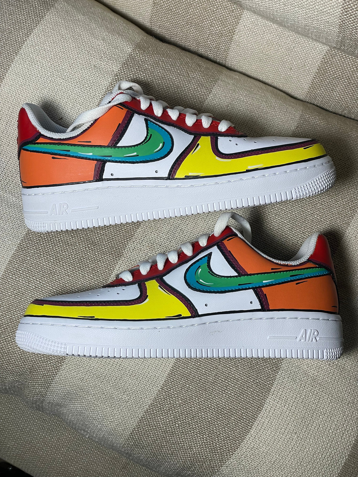 Colorful streetwear sneakers with cartoon-inspired design, teal swoosh, orange and yellow panels.