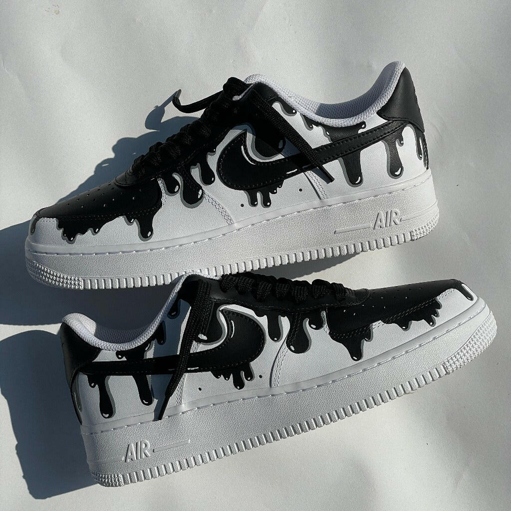Custom black and white streetwear sneakers with drip paint design on a white background