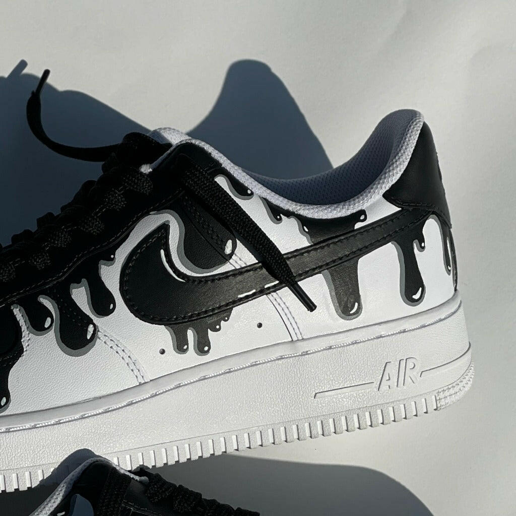 Black and white streetwear sneaker with drip paint design, luxury footwear closeup