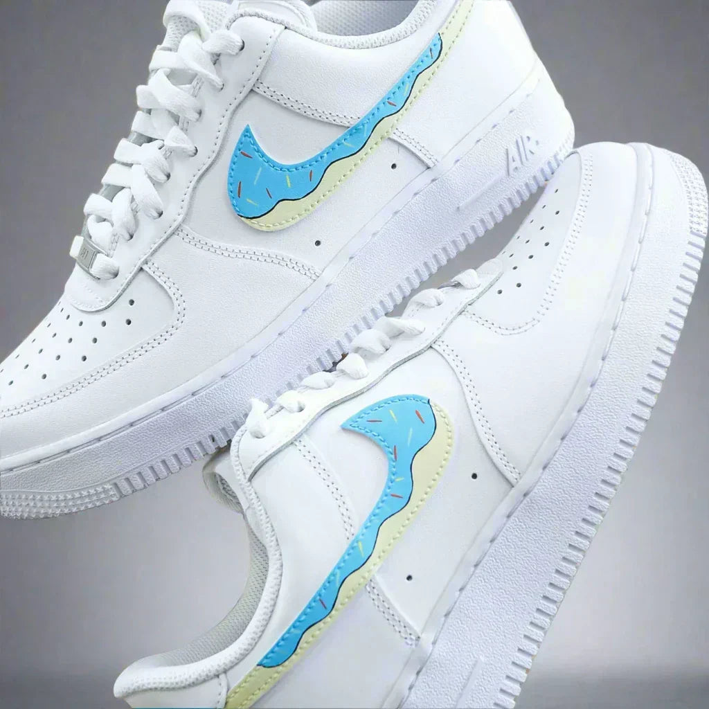 White streetwear sneakers with blue and yellow wavy Nike swoosh, limited edition style