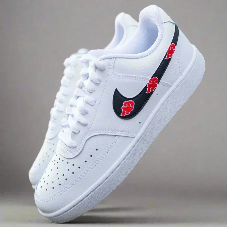 White streetwear sneakers with black swoosh and red cloud accents, limited edition style