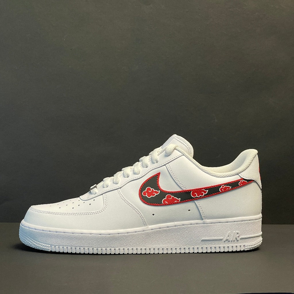 White streetwear sneaker with custom red and black Swoosh detail on grey background