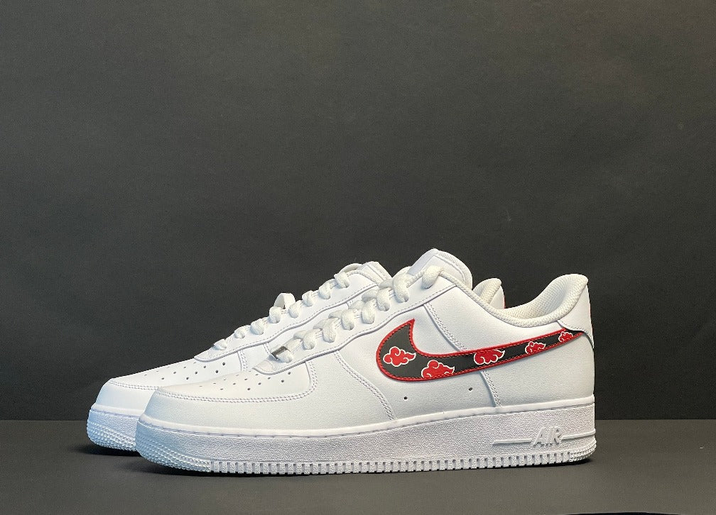 White streetwear sneakers with a custom red and black swoosh, limited edition style