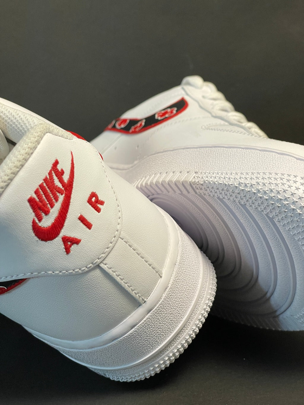 White Nike Air sneakers with red logo and floral graphic, streetwear footwear closeup