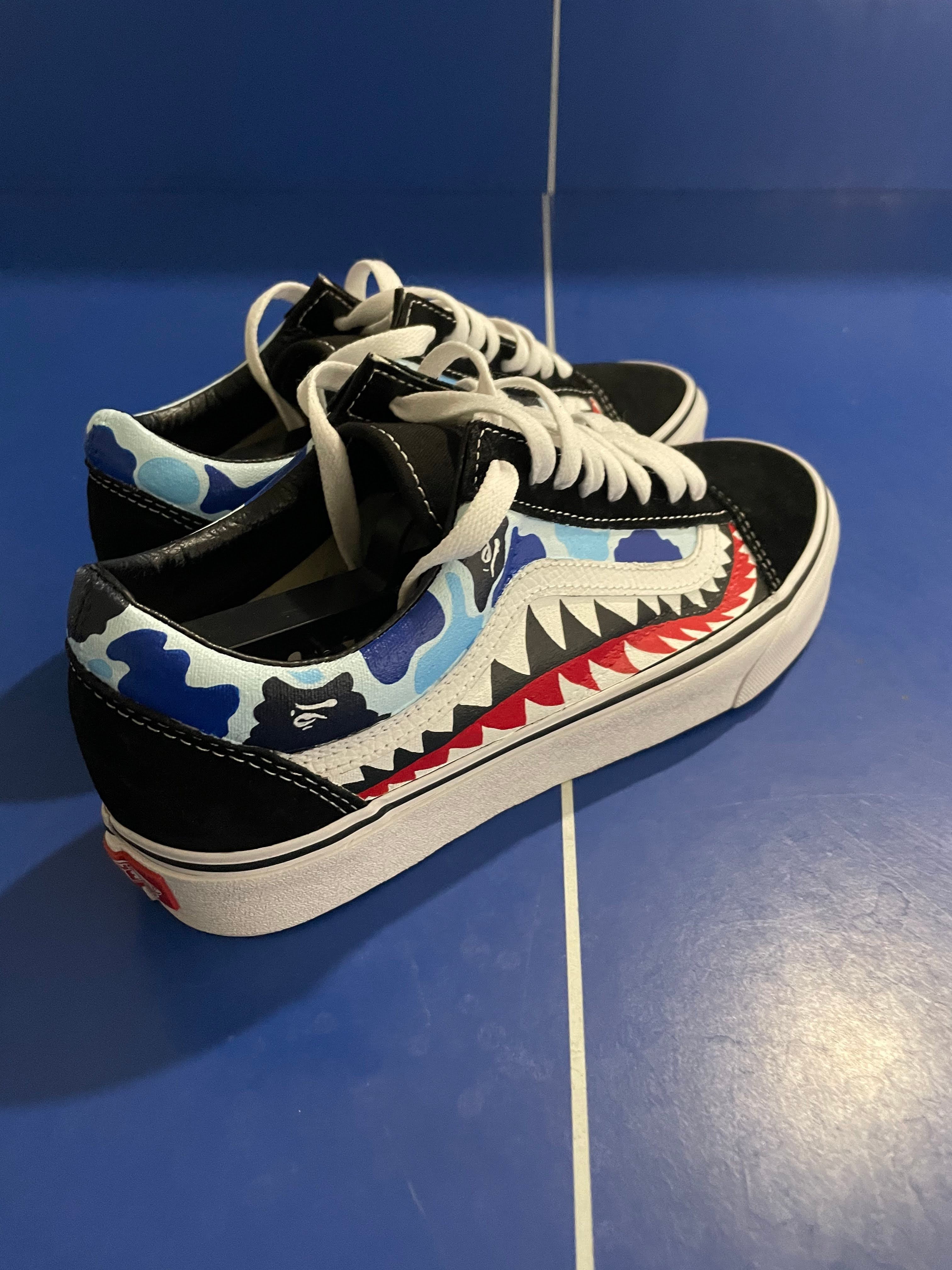 Streetwear sneakers with blue camo shark pattern and white soles on blue background
