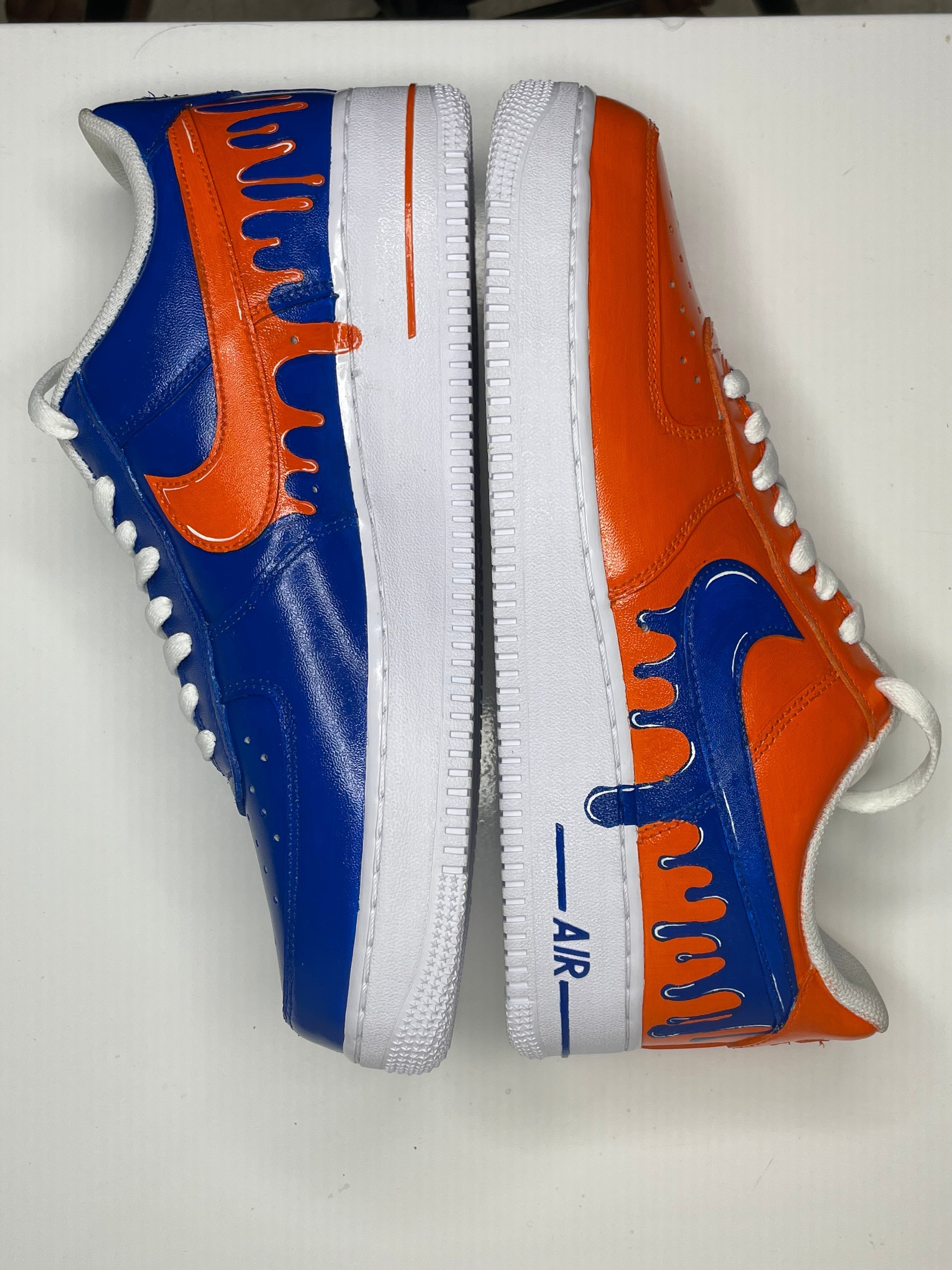Custom streetwear sneakers with blue and orange drip design, white soles, side view