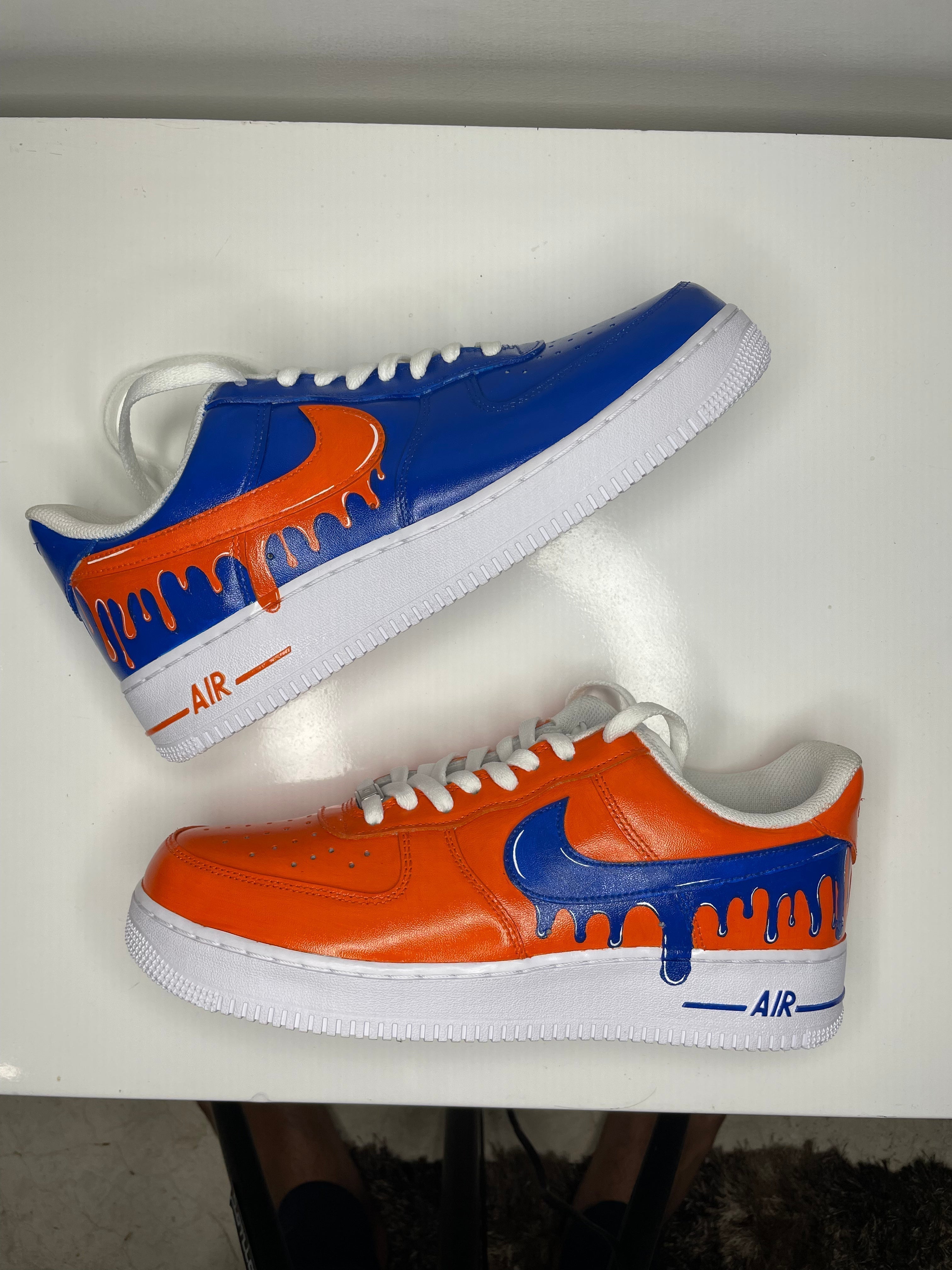 Custom low top sneakers with orange and blue drip design, white sole, streetwear style