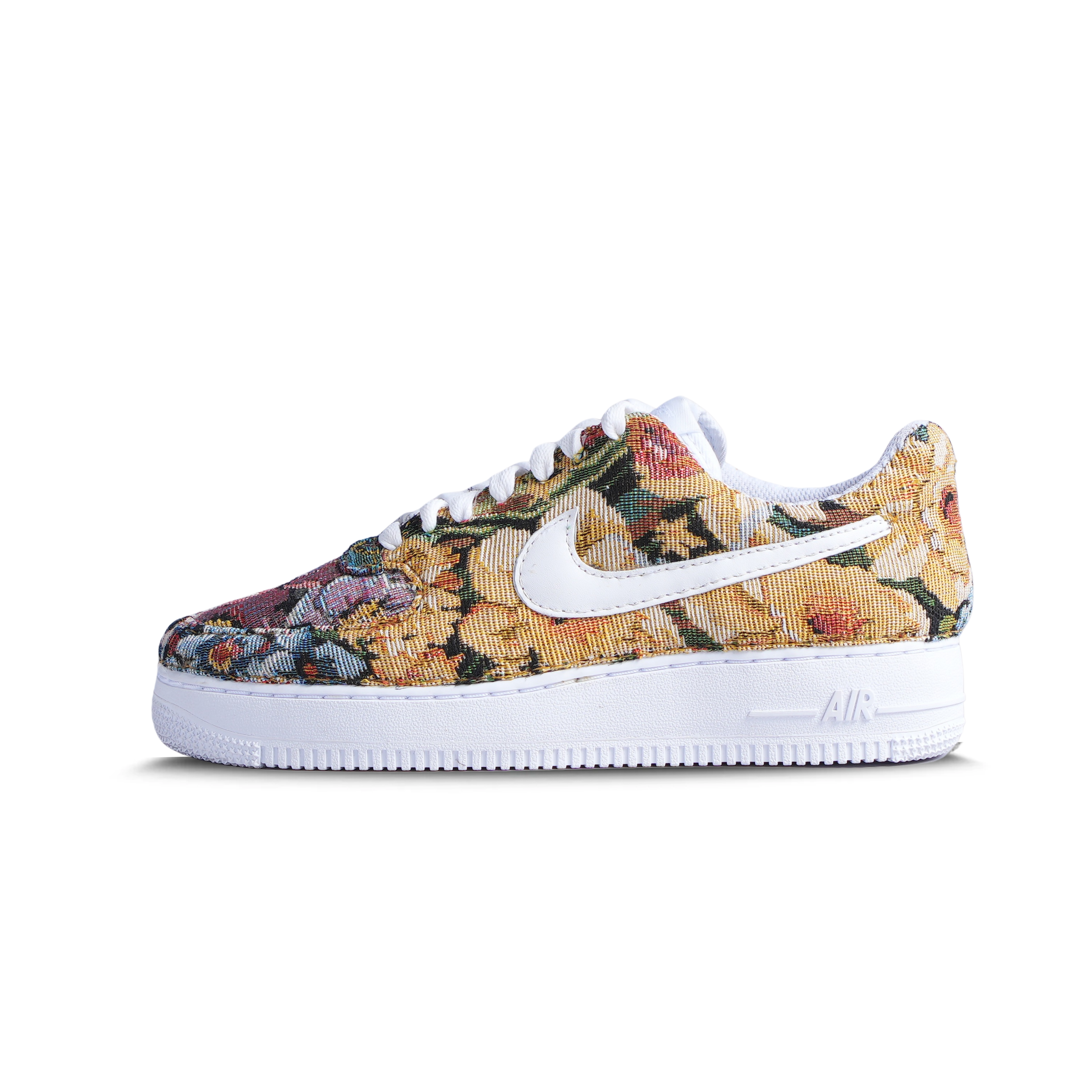 Low-top sneaker with multicolor floral jacquard upper, white swoosh, and white sole on white background