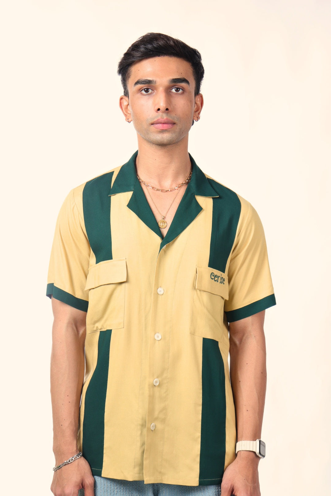 Man modeling a short sleeve, yellow and green colorblock bowling shirt with front pockets