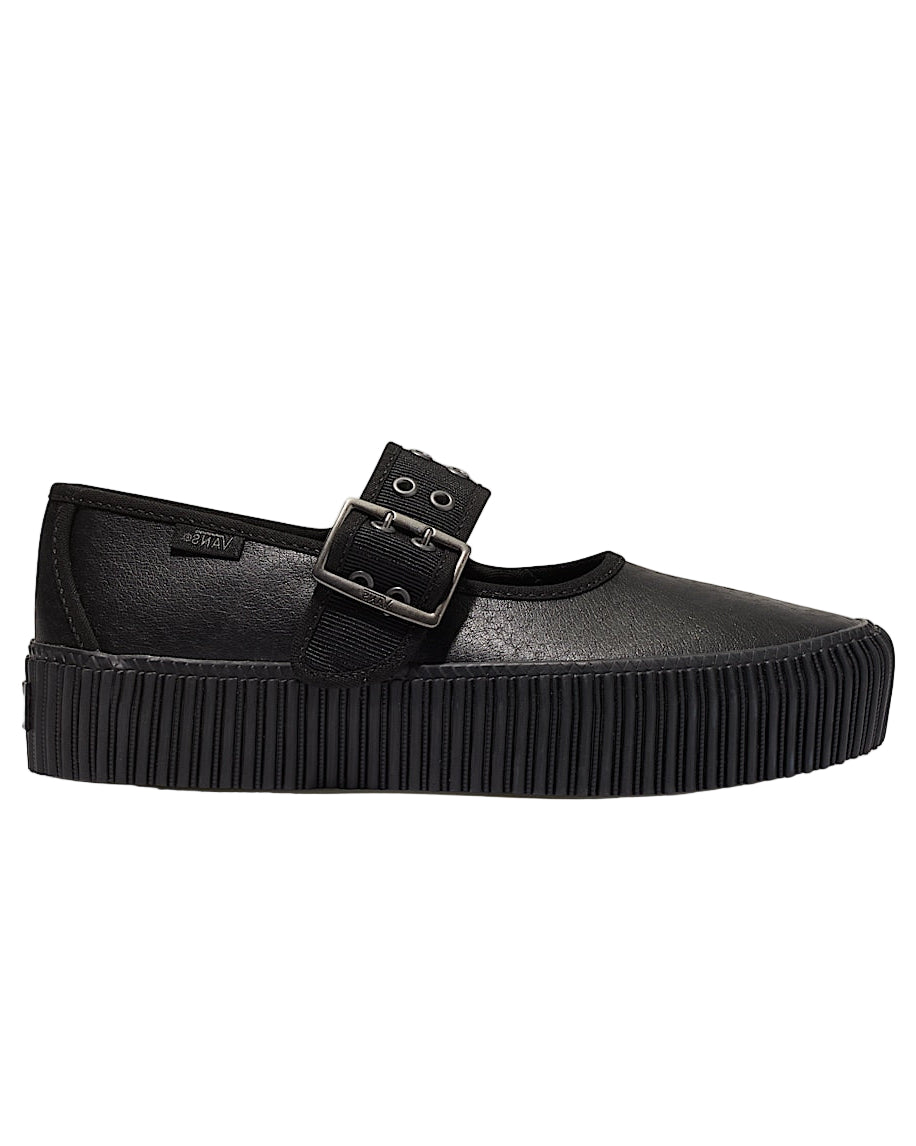 Black crepe sole shoe with a buckle on a light gray background