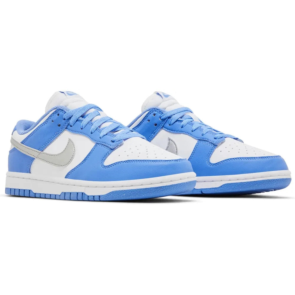 Light blue and white low-top sneakers with grey swoosh and perforated toe box