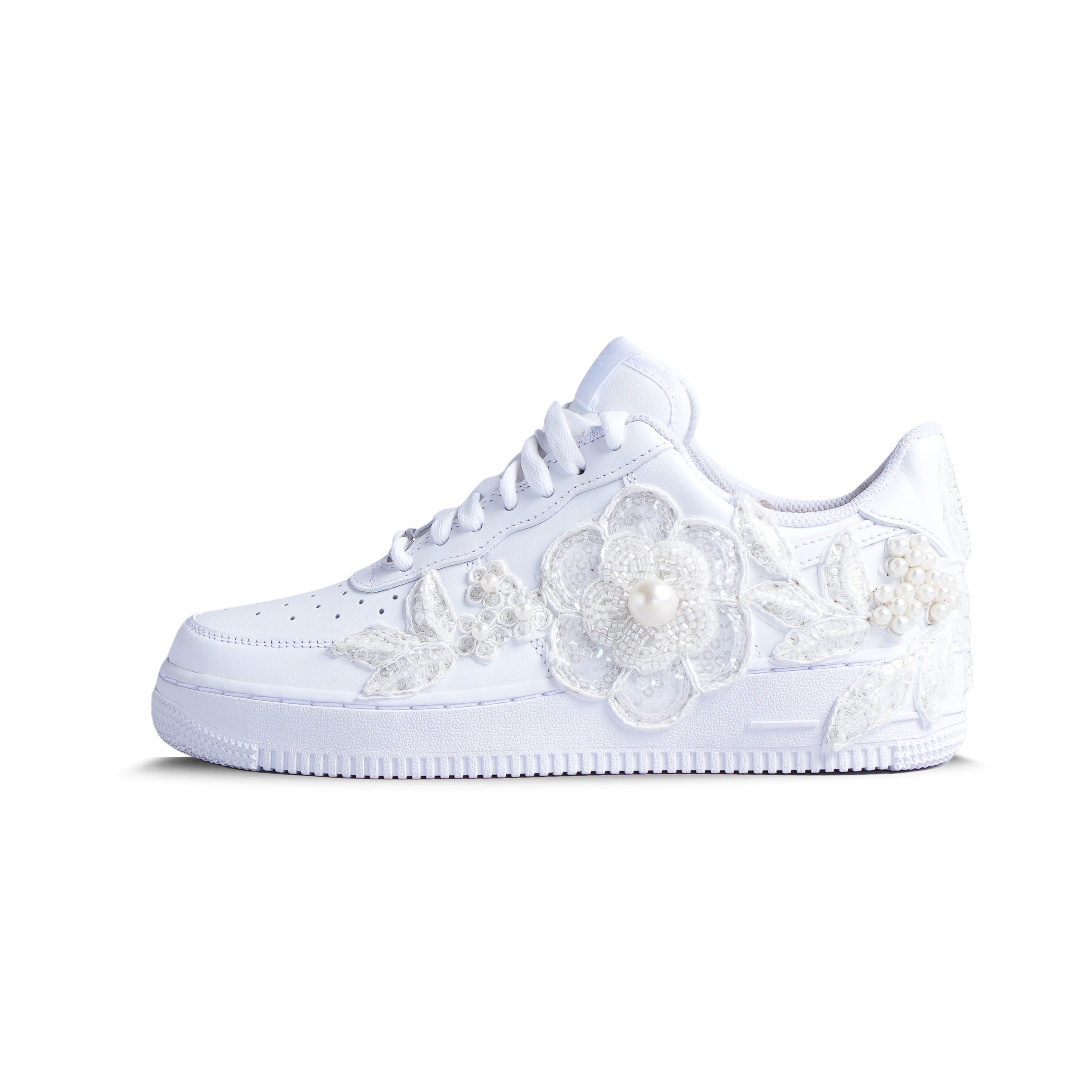 White sneaker with pearl and floral embroidery, luxury streetwear design on plain background