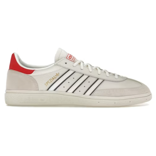 White low-top sneaker with black stripes, red heel tab, and gold SPEZIAL branding