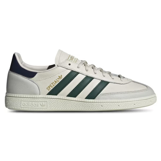 White leather sneaker with green stripes, gold 'SPEZIAL' text, and textured sole, side view.